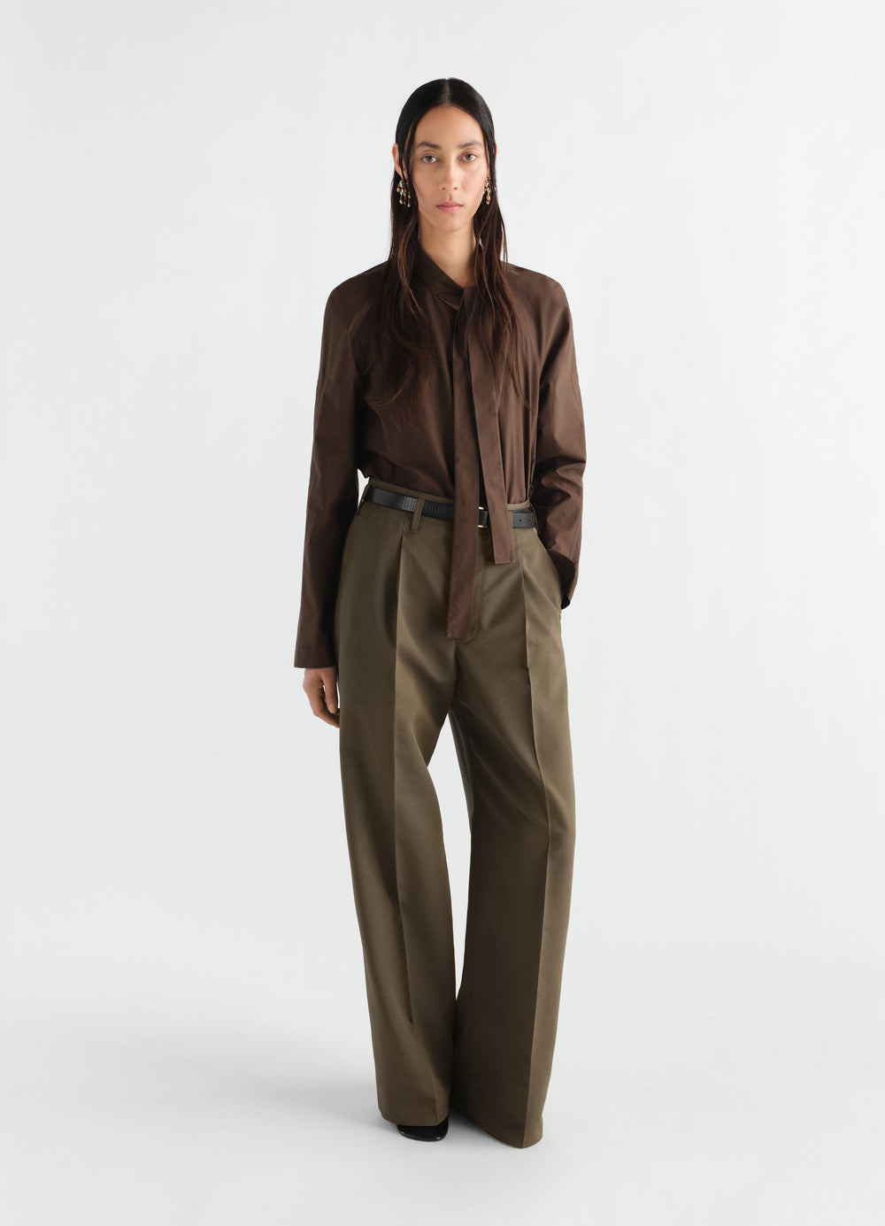 Ascot blouse in washed cotton silk brown worn by a model with olive trousers LEMAIRE