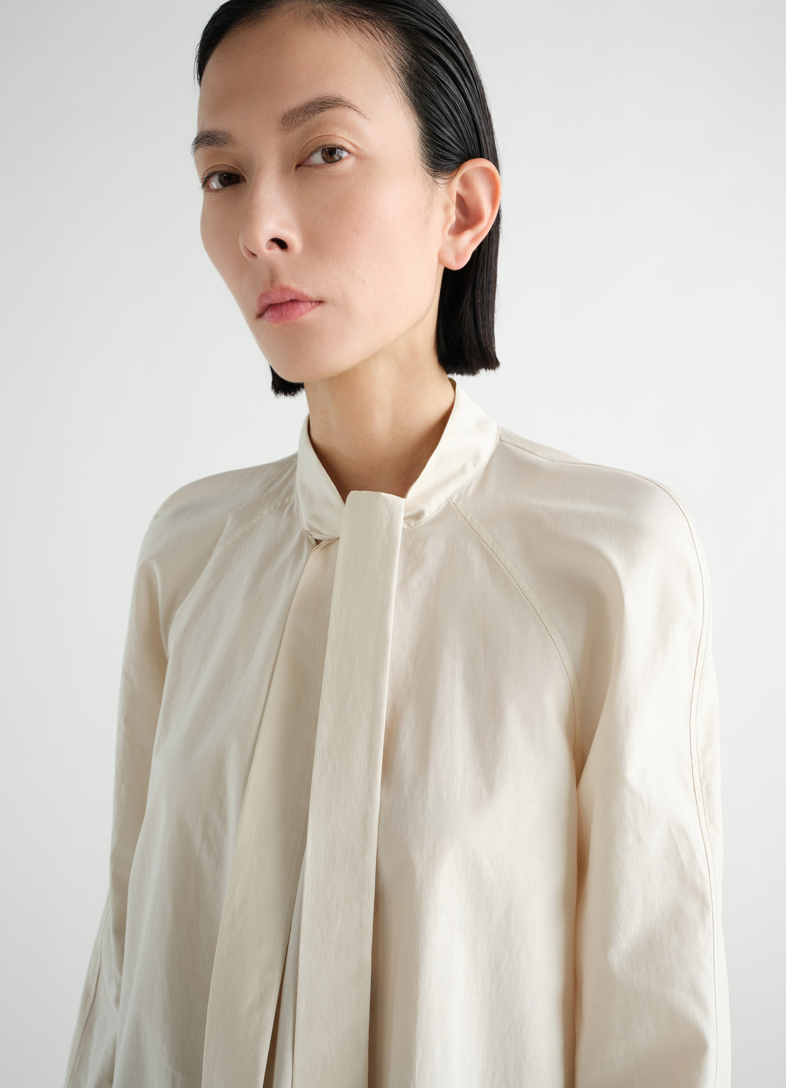 Ascot blouse in washed cotton silk in washed cotton silk, model shot, close-up side view ascot tie detail