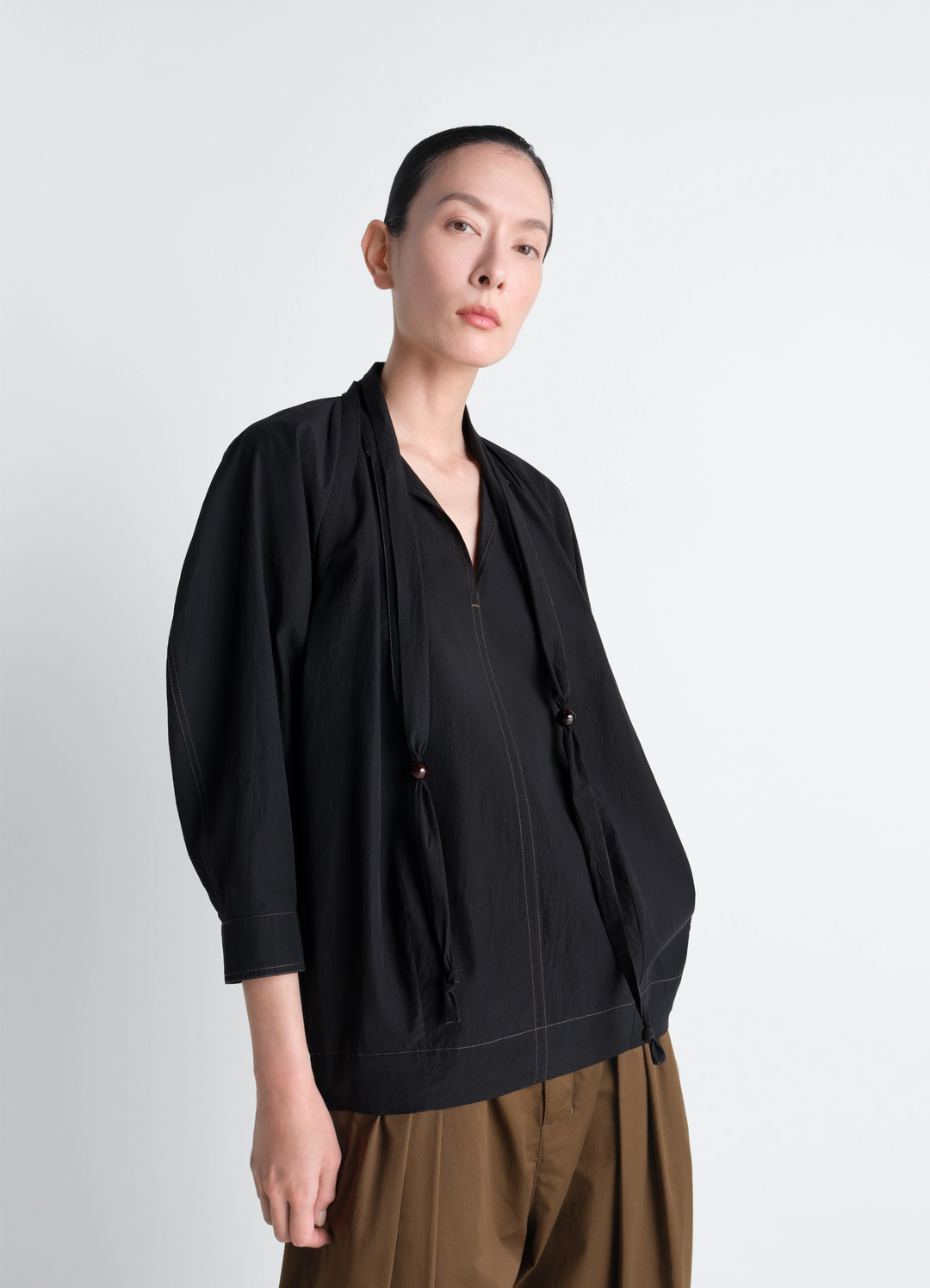 Lemaire Blouse with Scarf in Crepe Cotton Black, model shot, Front side view Integrated scarf detail