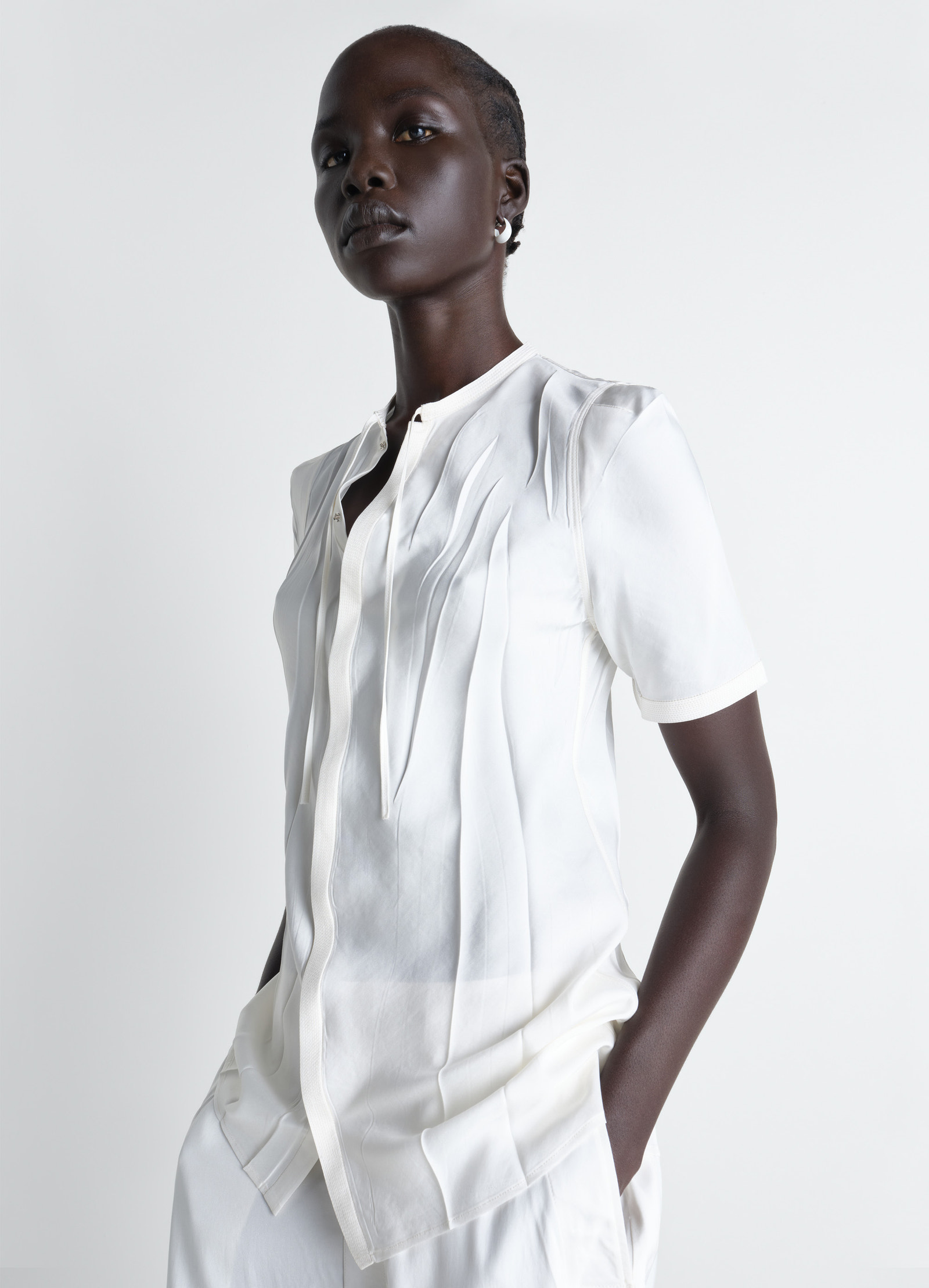 Creased fitted shirt in poly viscose twill, model shot, front side view irregular pleats fitted