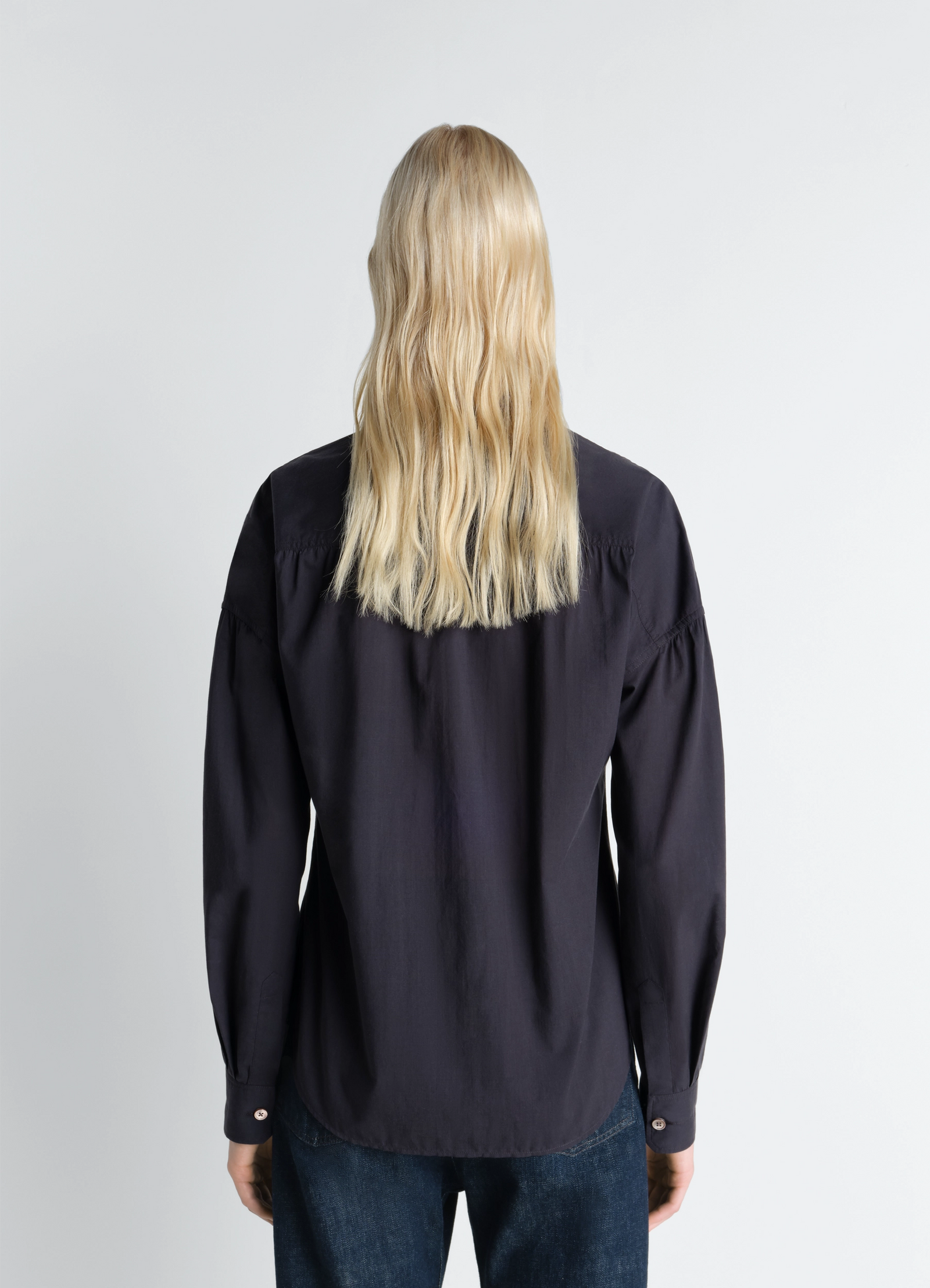 Lemaire soft pointed collar shirt in washed cotton muslin, model shot, back view buttoned cuffs