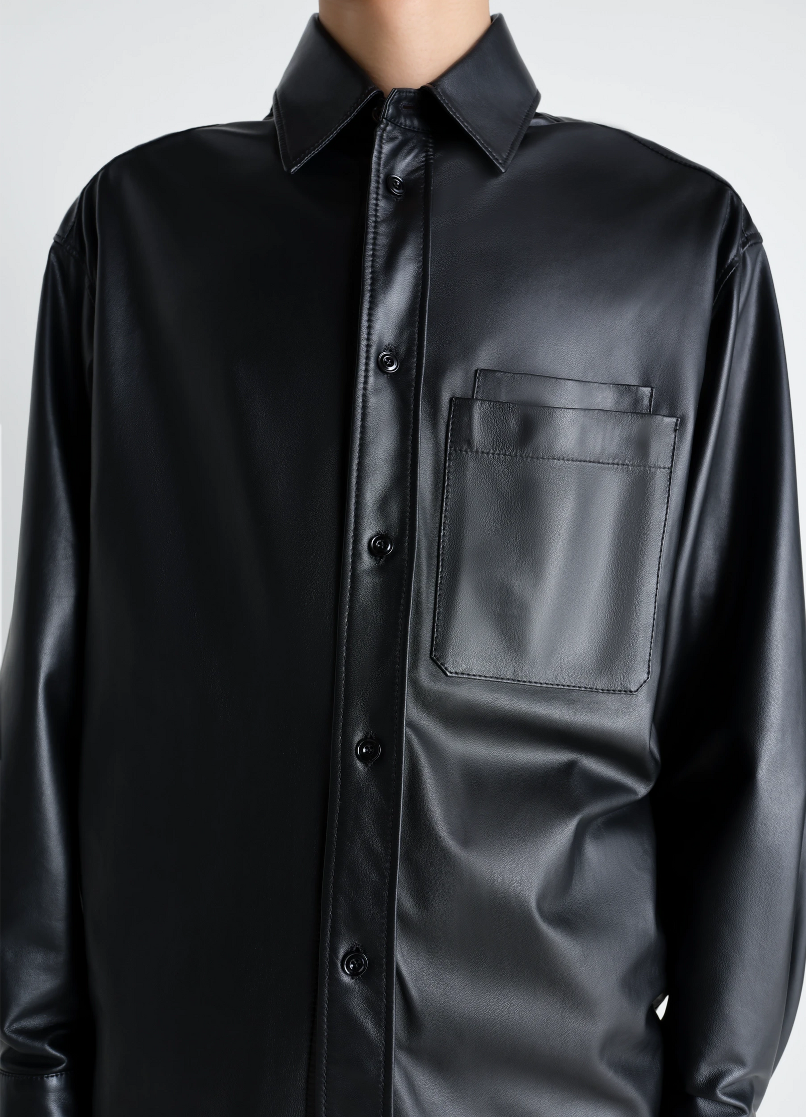 Overshirt in light nappa lamb in black lamb nappa leather, model shot, close-up front chest chest pocket detail