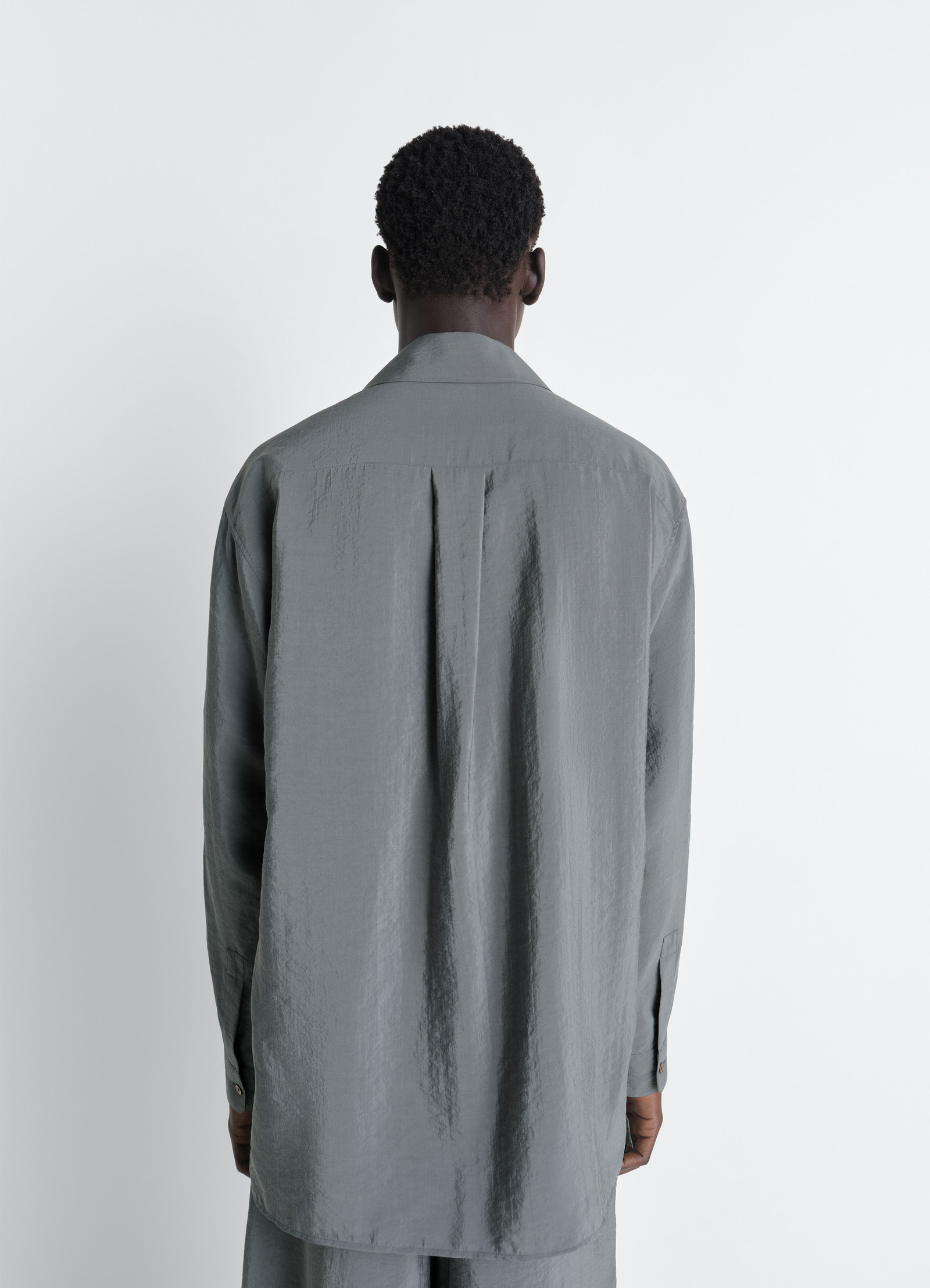 Lemaire convertible collar shirt in dry silk, model shot, back view single inverted pleat