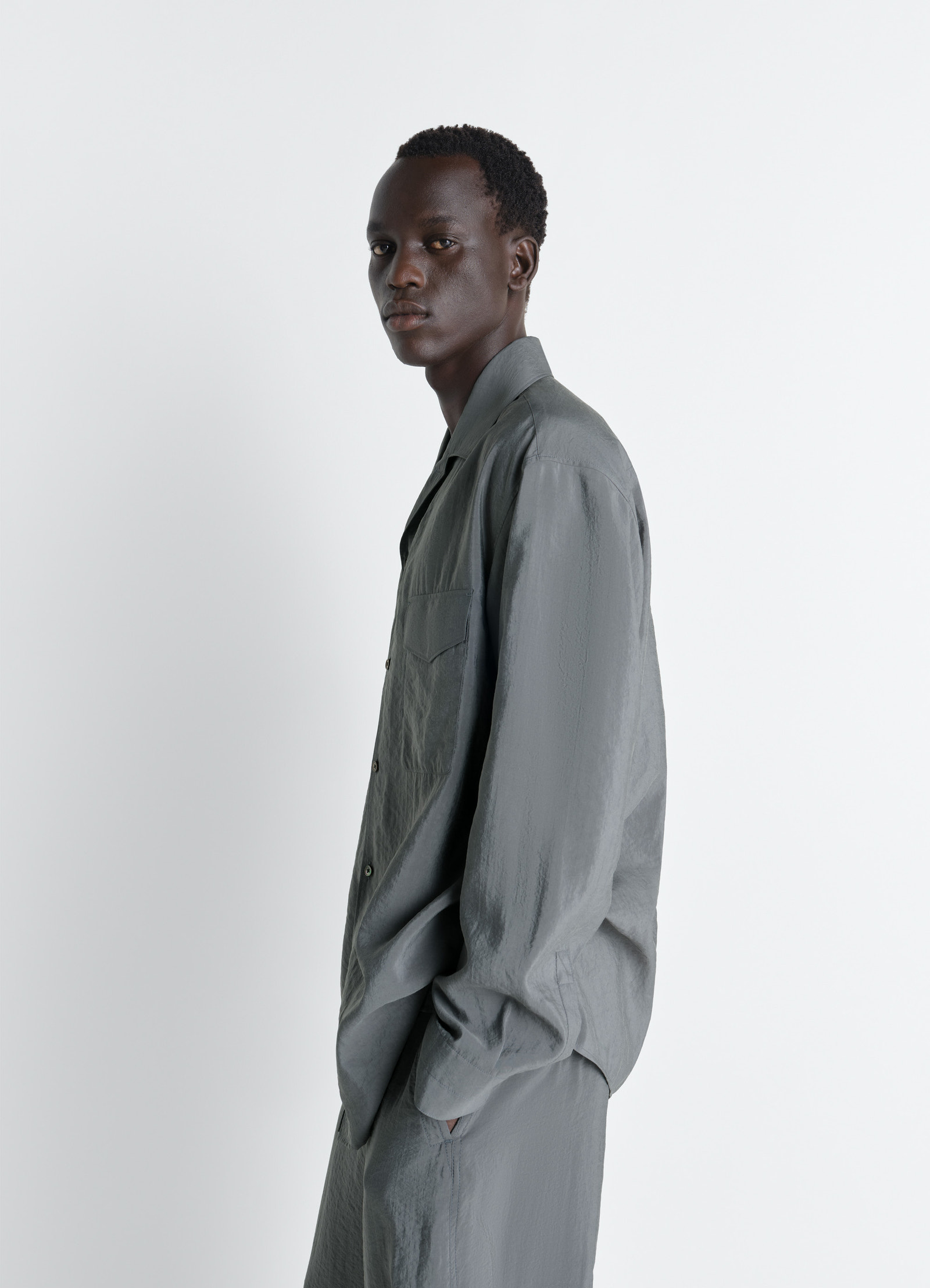 Lemaire convertible collar shirt in dry silk, model shot, side view smooth texture