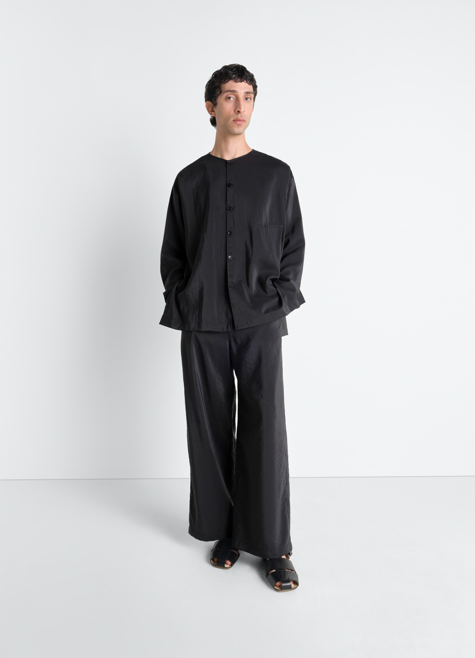 Lemaire v-neck shirt in black dry silk, model shot, three-quarter view relaxed fit, button fasten