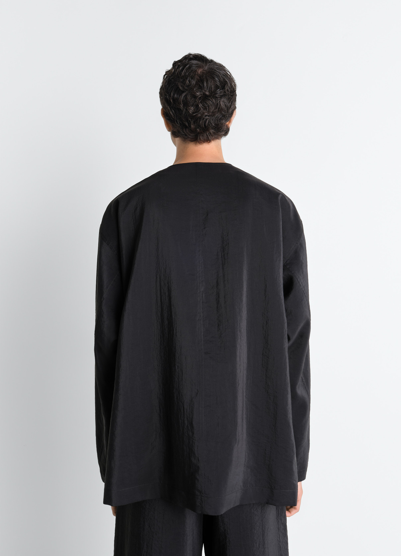 Lemaire v-neck shirt in black dry silk, model shot, back view long sleeves