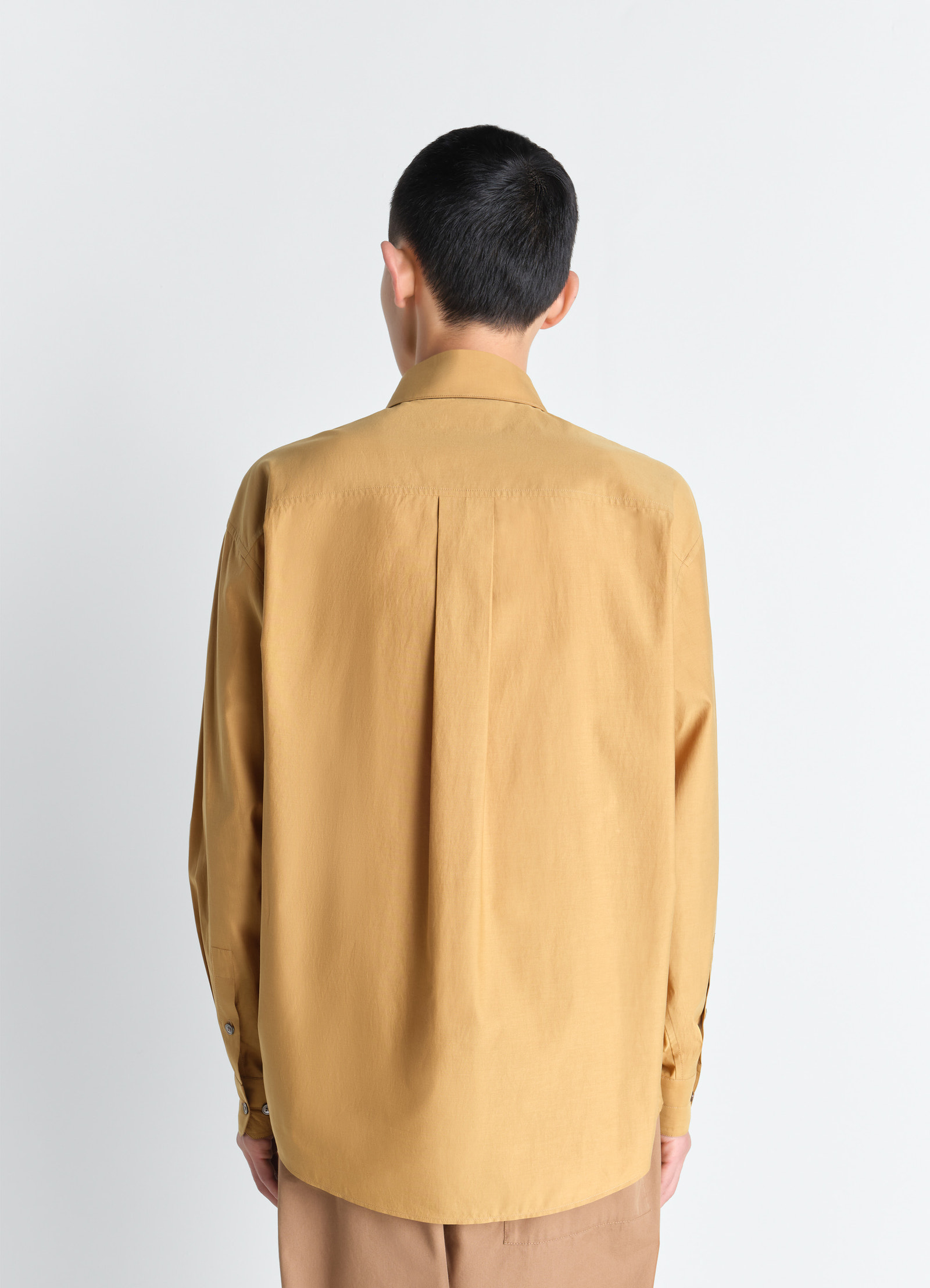 Lemaire regular shirt in washed cotton silk, model shot, back view curved hem design