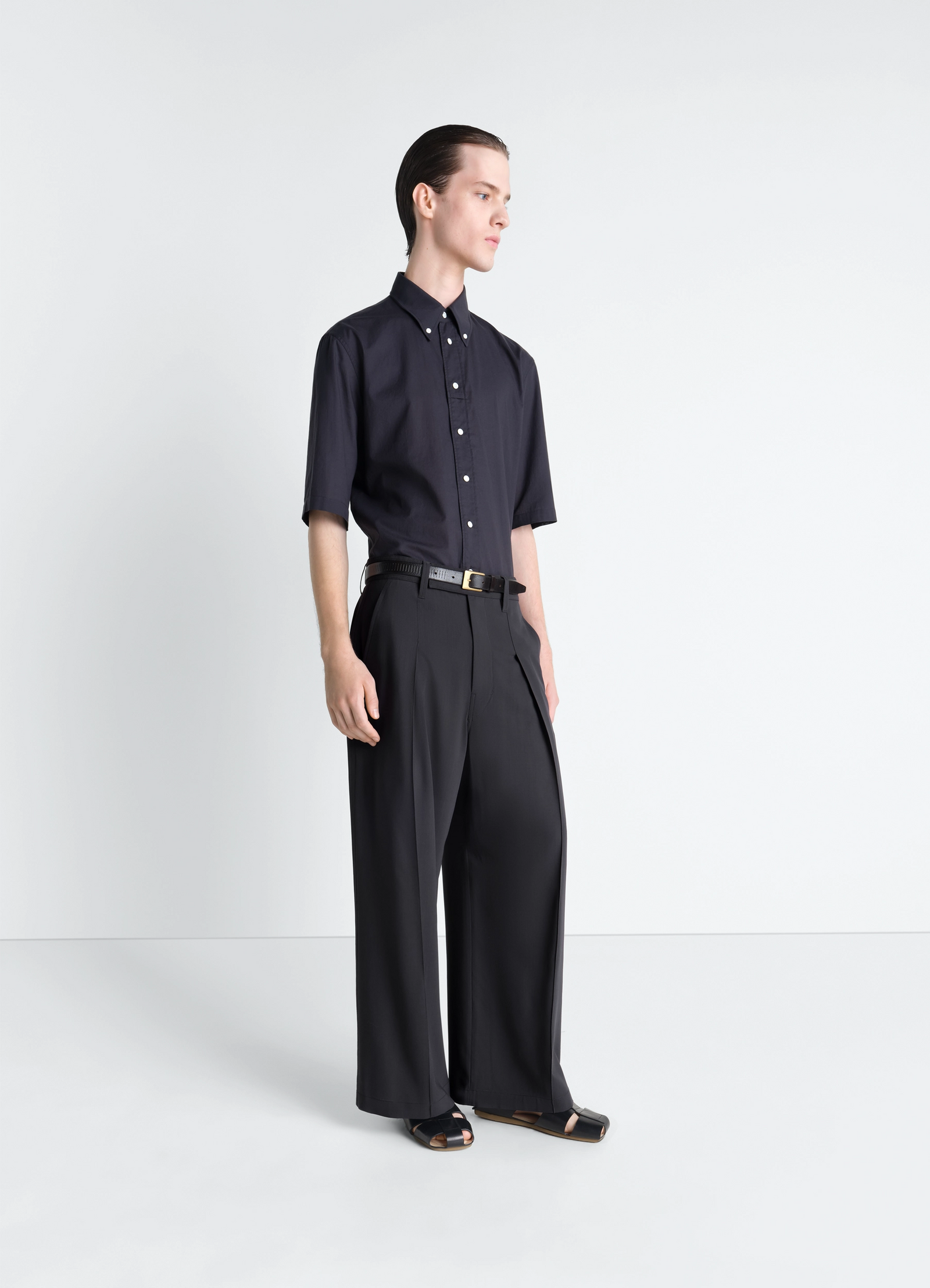 Lemaire short sleeve shirt in washed cotton muslin, model shot, three-quarter view tucked in waistband