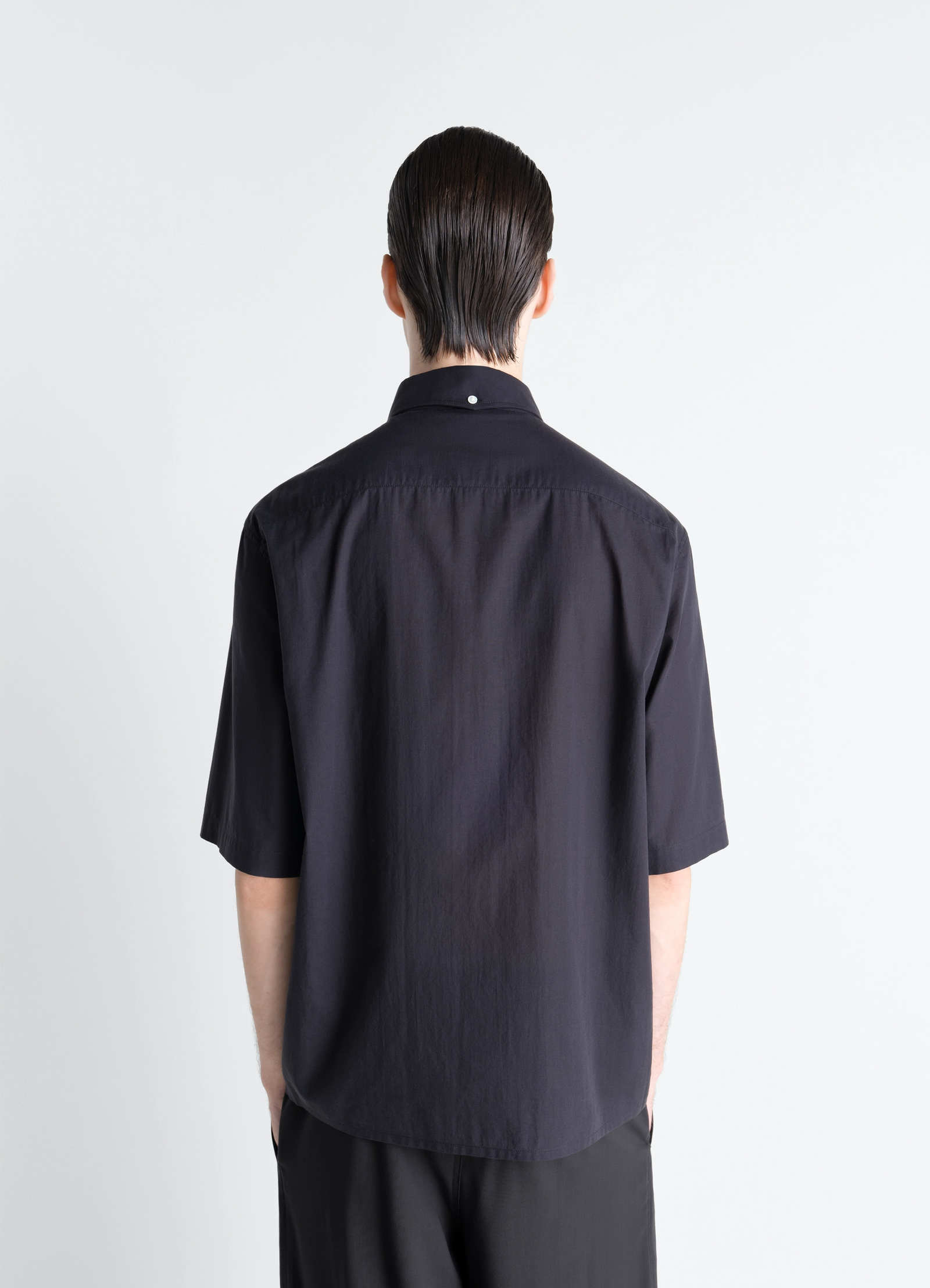 Lemaire short sleeve shirt in washed cotton muslin, model shot, back view straight hem, back pleat