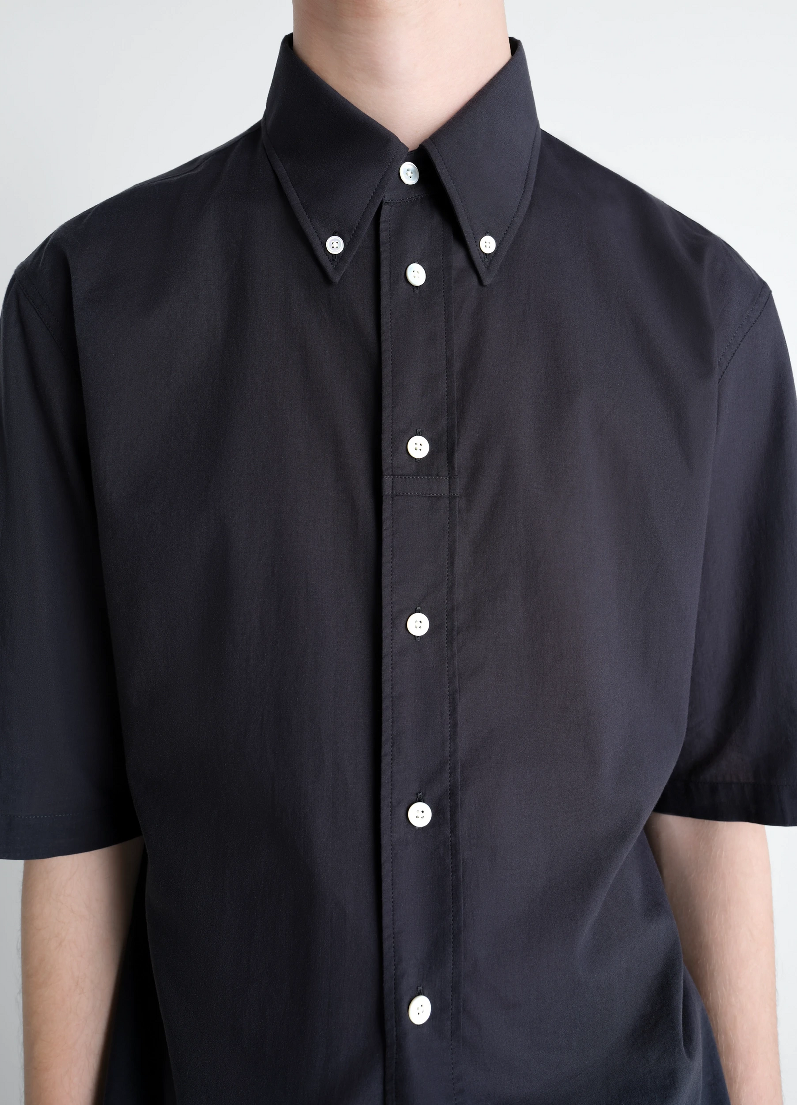 Lemaire short sleeve shirt in washed cotton muslin, model shot, detail shot unbuttoned loose fit