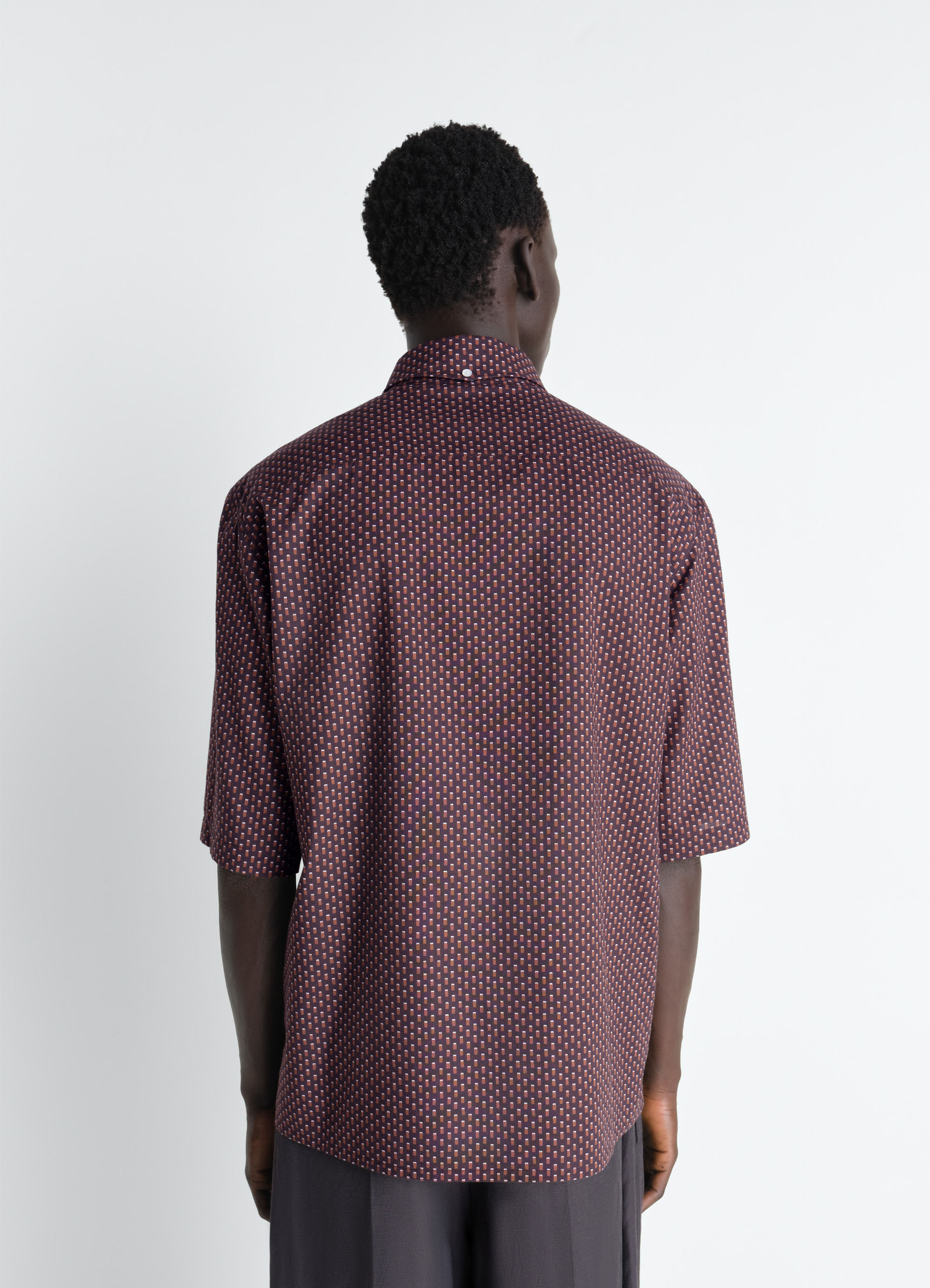 Lemaire short sleeve shirt in geometric printed cotton, model shot, back view relaxed fit with draped back