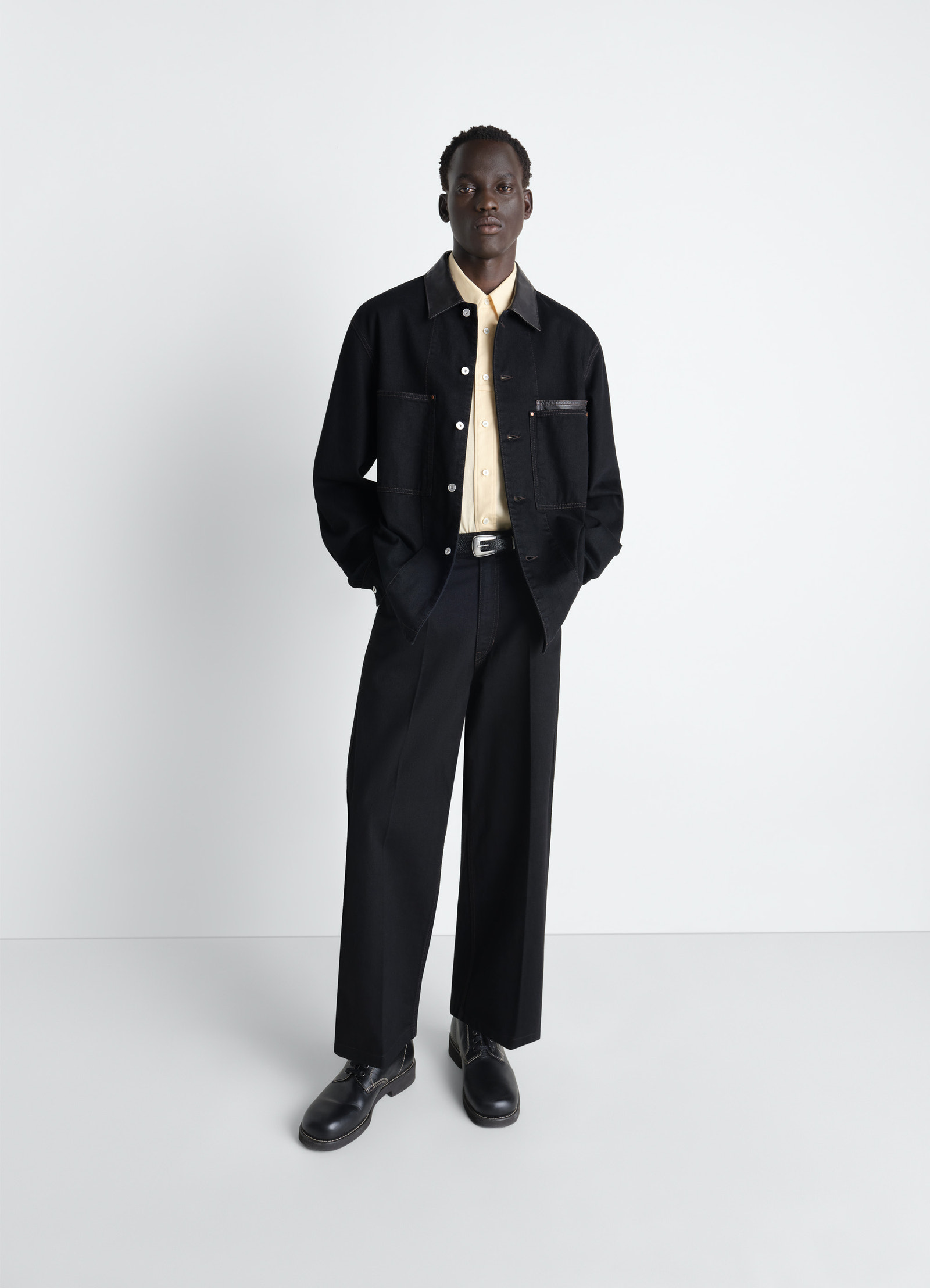 Workwear overshirt with leather col in black denim and leather, model shot, front view oversized fit with side pockets