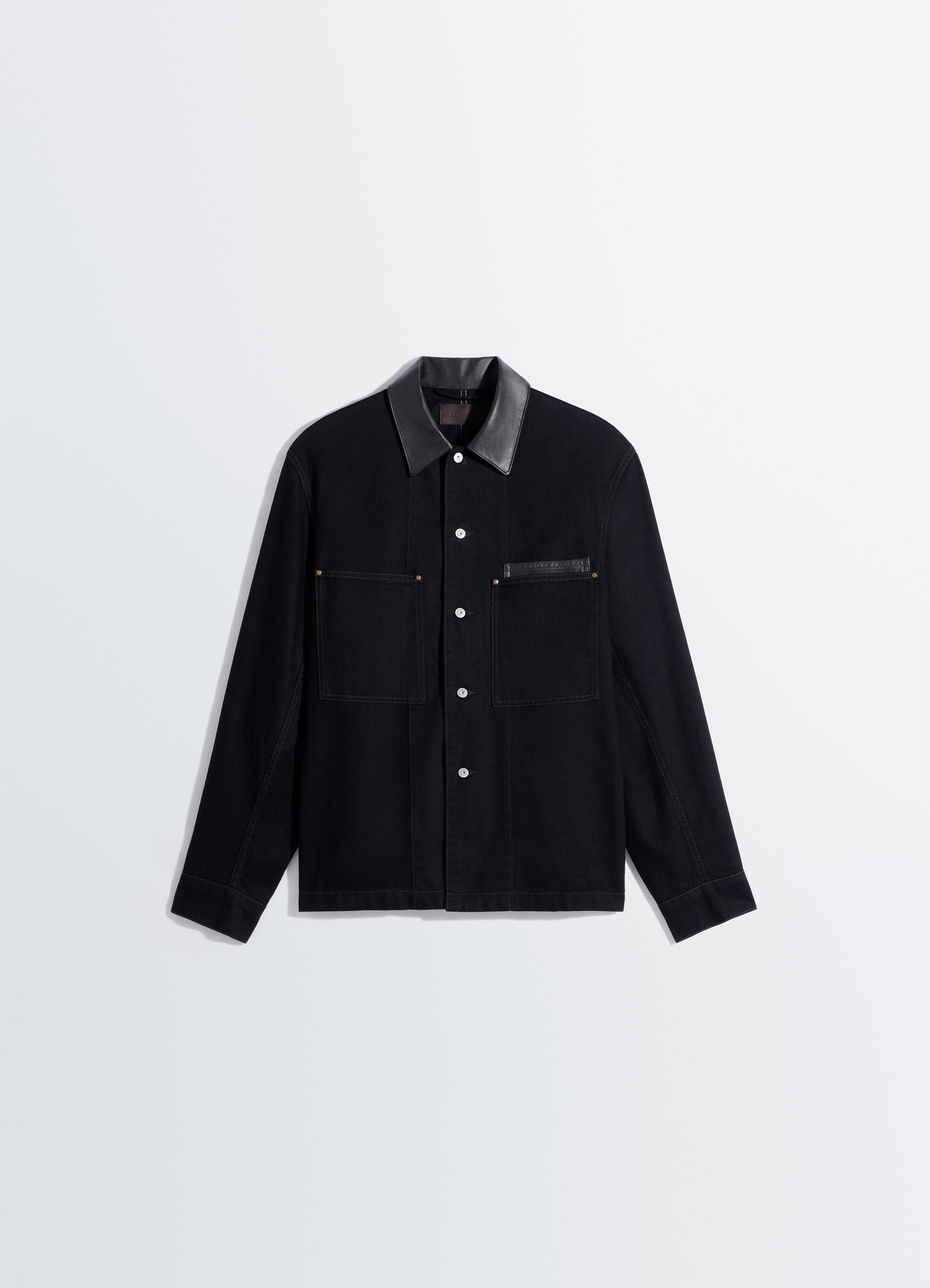 Workwear overshirt with leather col in black denim and leather, product shot, angled top view button-down with cuffed sleeves