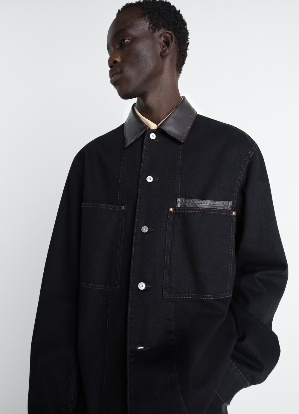 Workwear Overshirt with Leather Col in Black Denim and Leather, model shot, Side view Classic cut with chest pockets