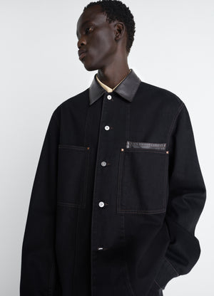 Workwear overshirt with leather col in black denim and leather, model shot, side view classic cut with chest pockets