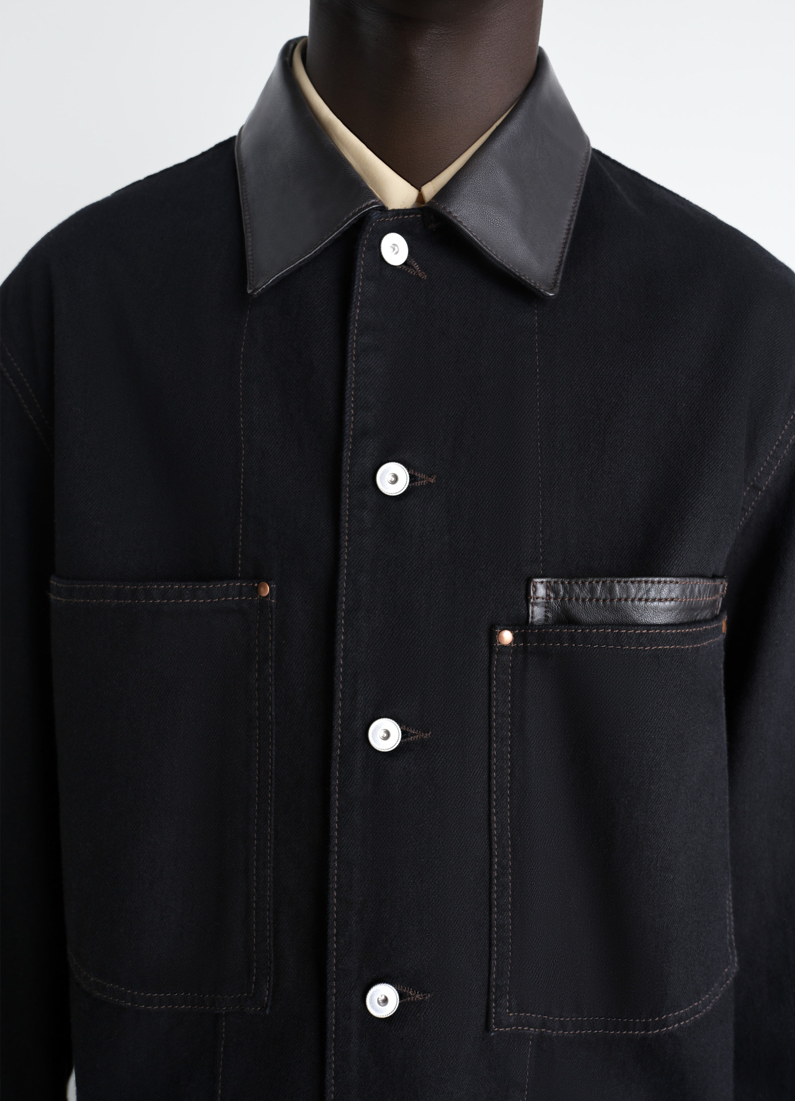 Workwear overshirt with leather col in black denim and leather, model shot, detail shot button placket, leather collar