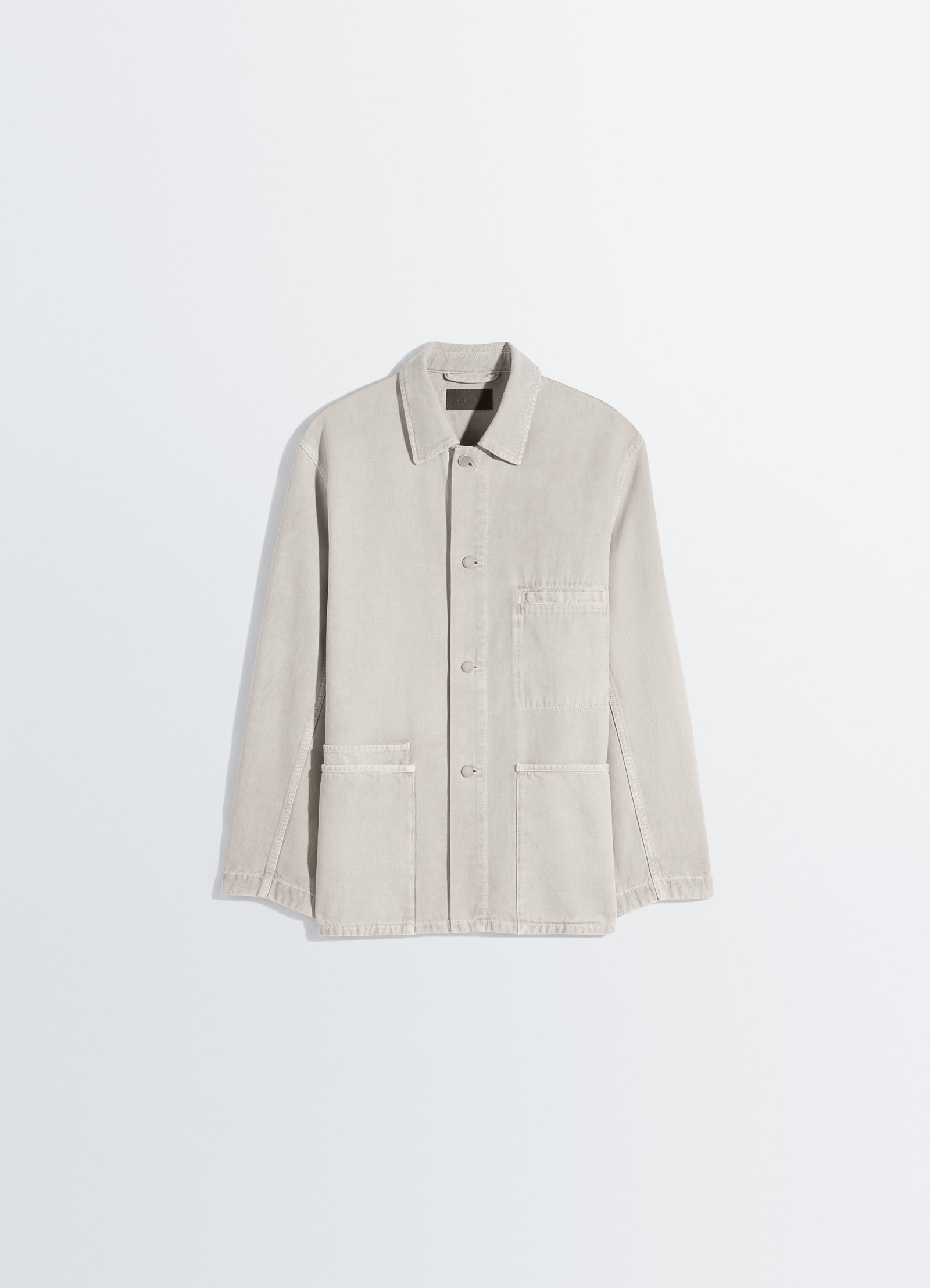 Utility overshirt in snow broken twill, product shot, angled top view hip-length hem, button front