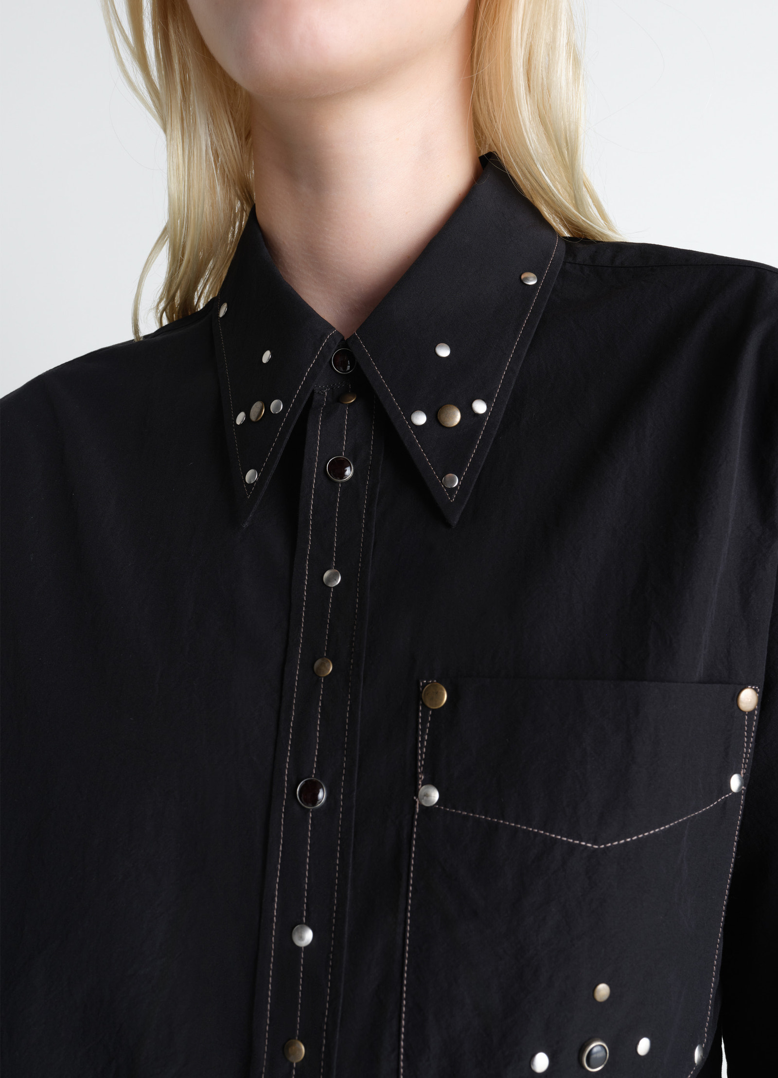 Fitted shirt with studs in black cotton crepe, model shot, close-up detail shot collar and chest studs