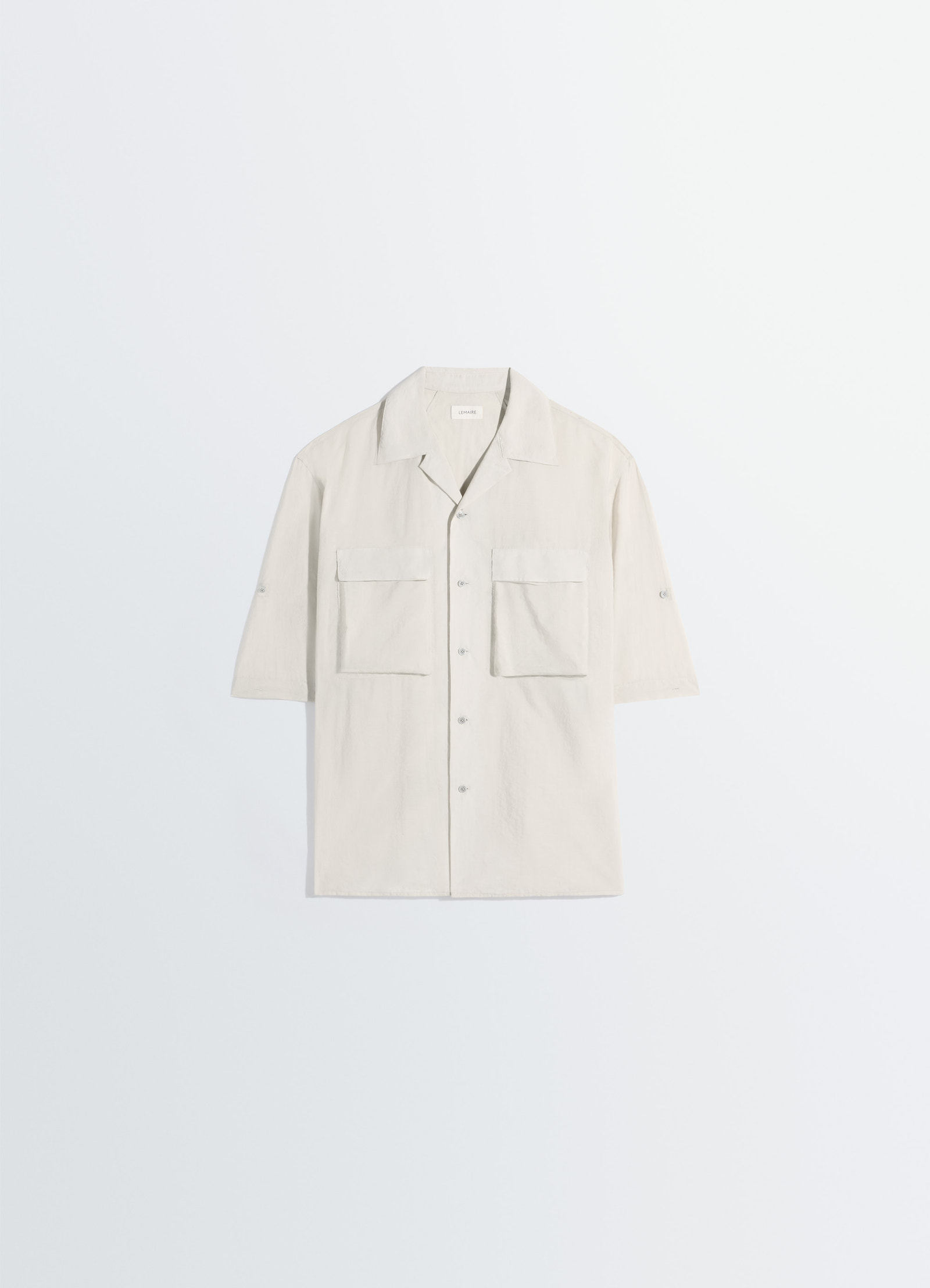 Short sleeve utility shirt in washed technical cotton, product shot, hanging front detail button-down collar, loose cut