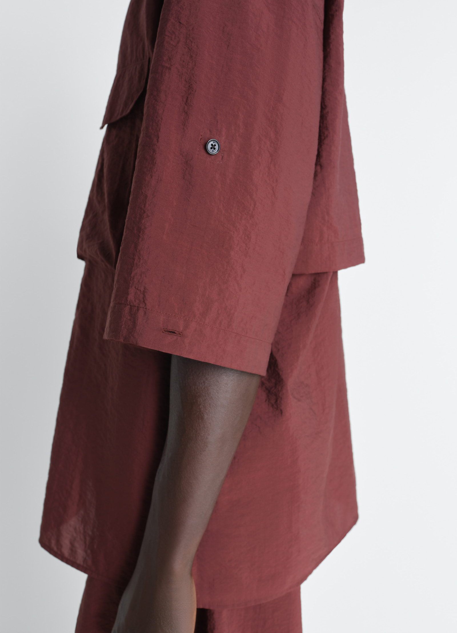 Short sleeve utility shirt in washed technical cotton, model shot, close-up side detail cuffed sleeve button detail