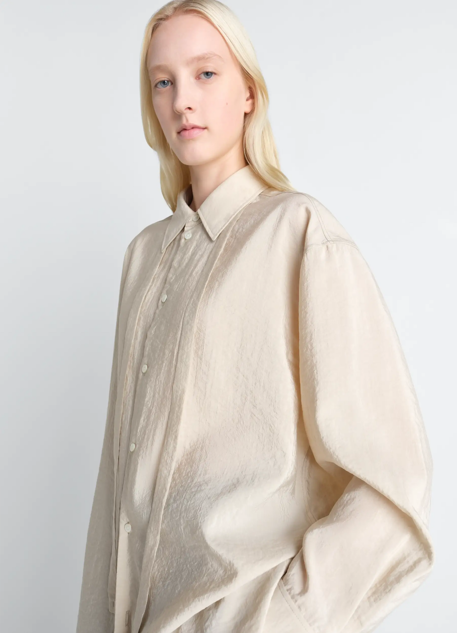 Lemaire long shirt with tie in dry silk, model shot, side profile view relaxed fit, buttoned cuffs