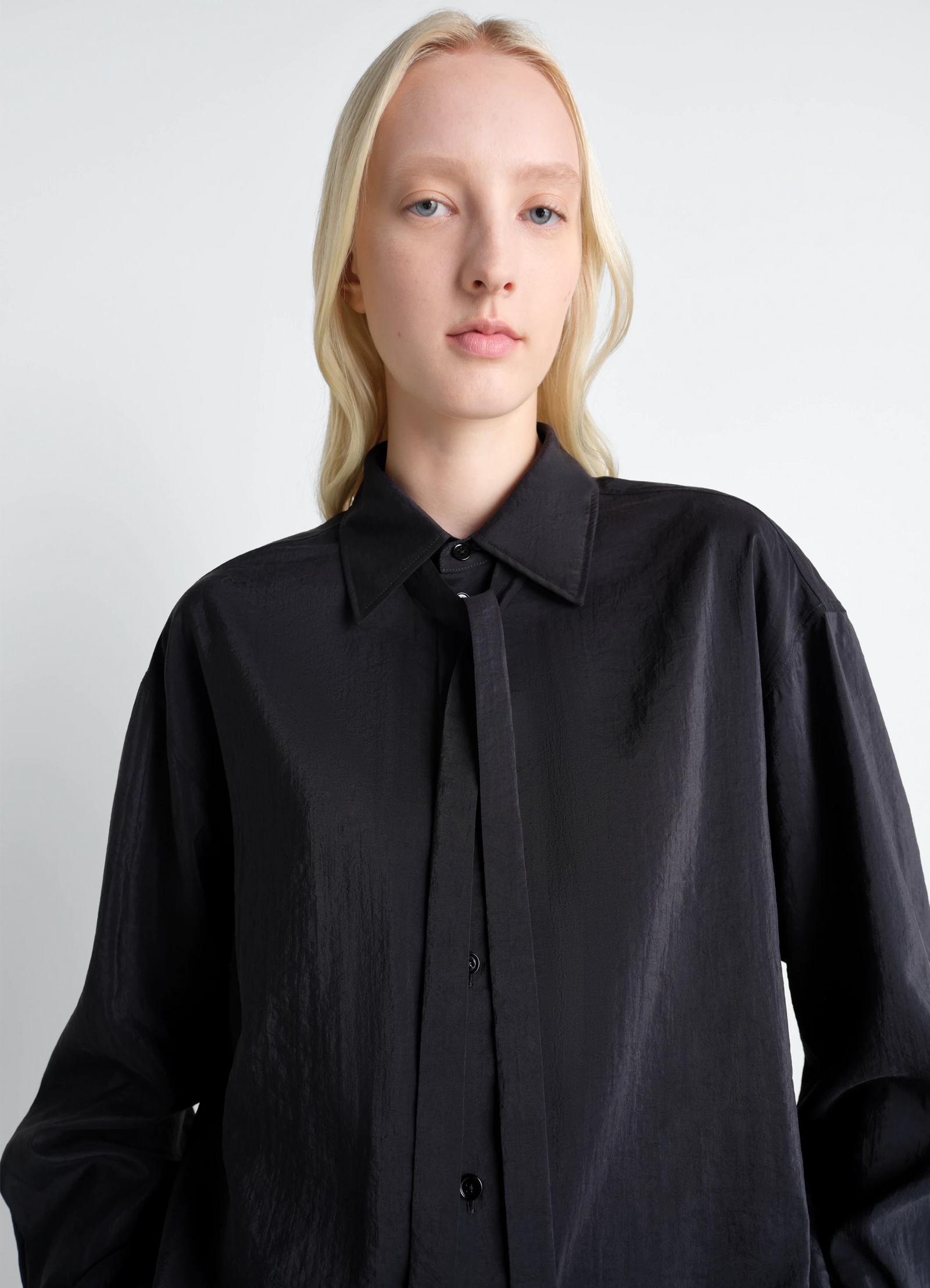 Lemaire long shirt with tie in black dry silk blend, model shot, close-up view structured collar design