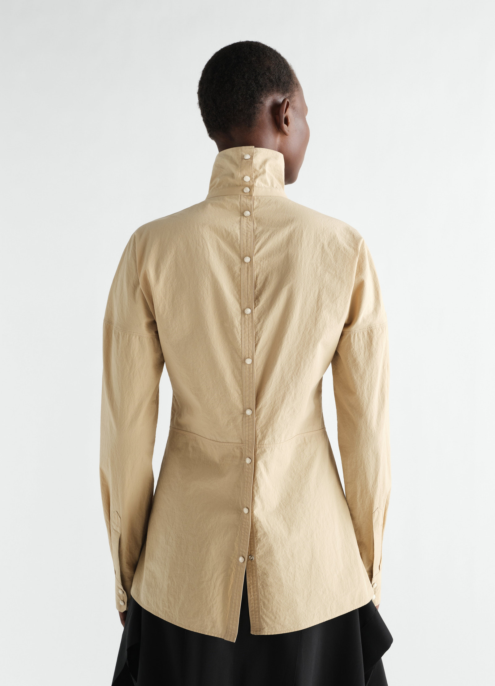 Press-stud beige cotton crepe bib top by lemaire, back view worn by model with high collar and button details