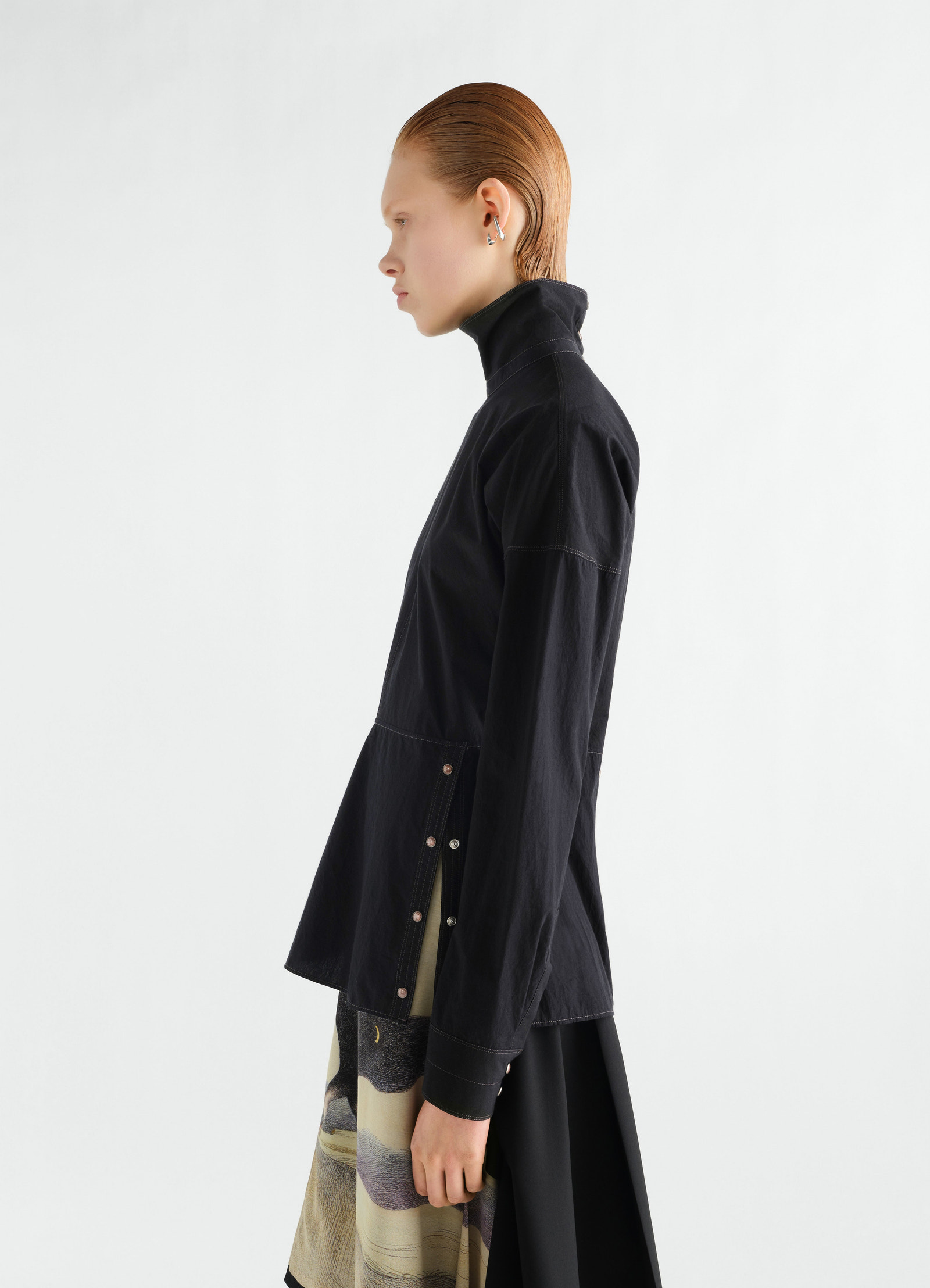 Press-stud bib top in black cotton crepe by lemaire worn by model side view with high neck and button details