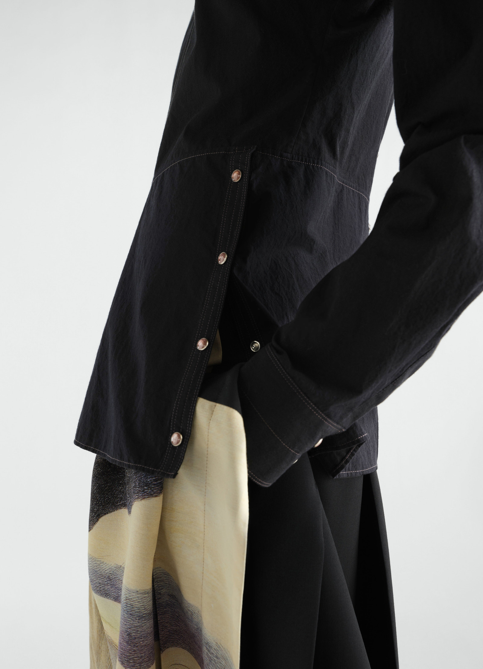 Press-stud black cotton crepe bib top by lemaire worn by model showing side button details and sleeves