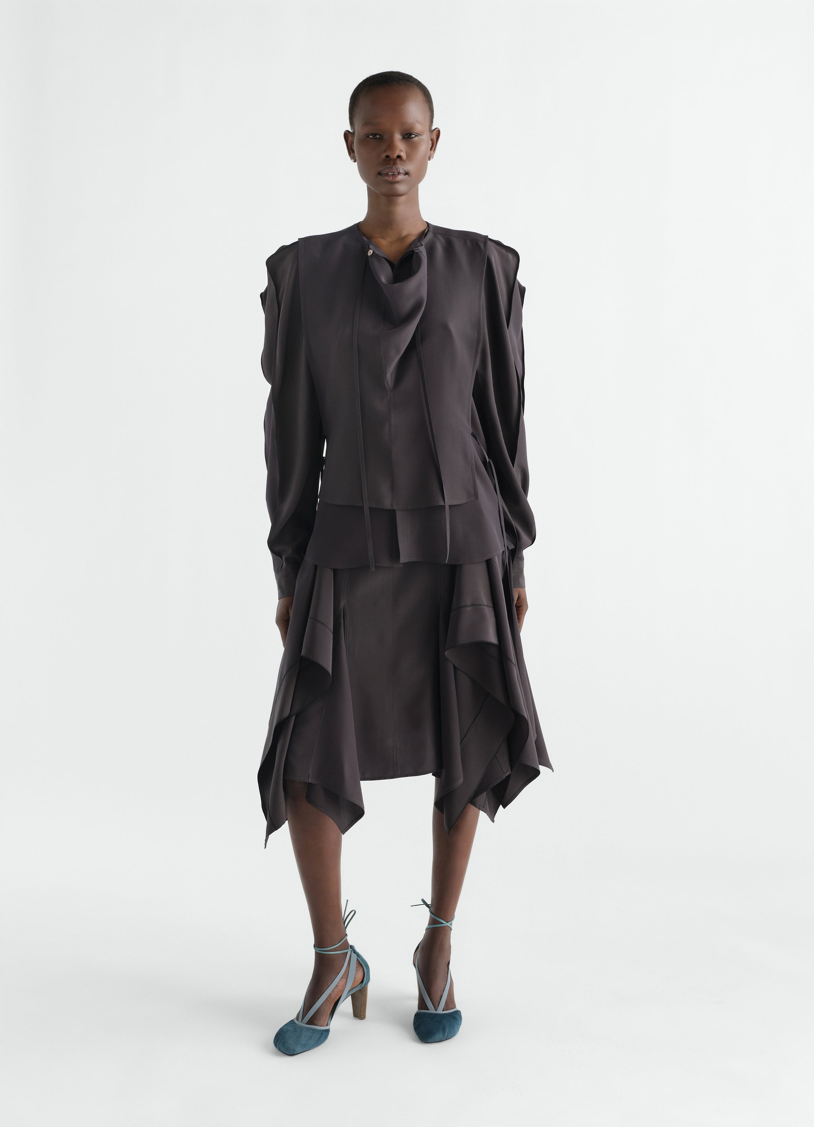 Layered black silk and viscose blouse with draped neckline worn by model lemaire front view