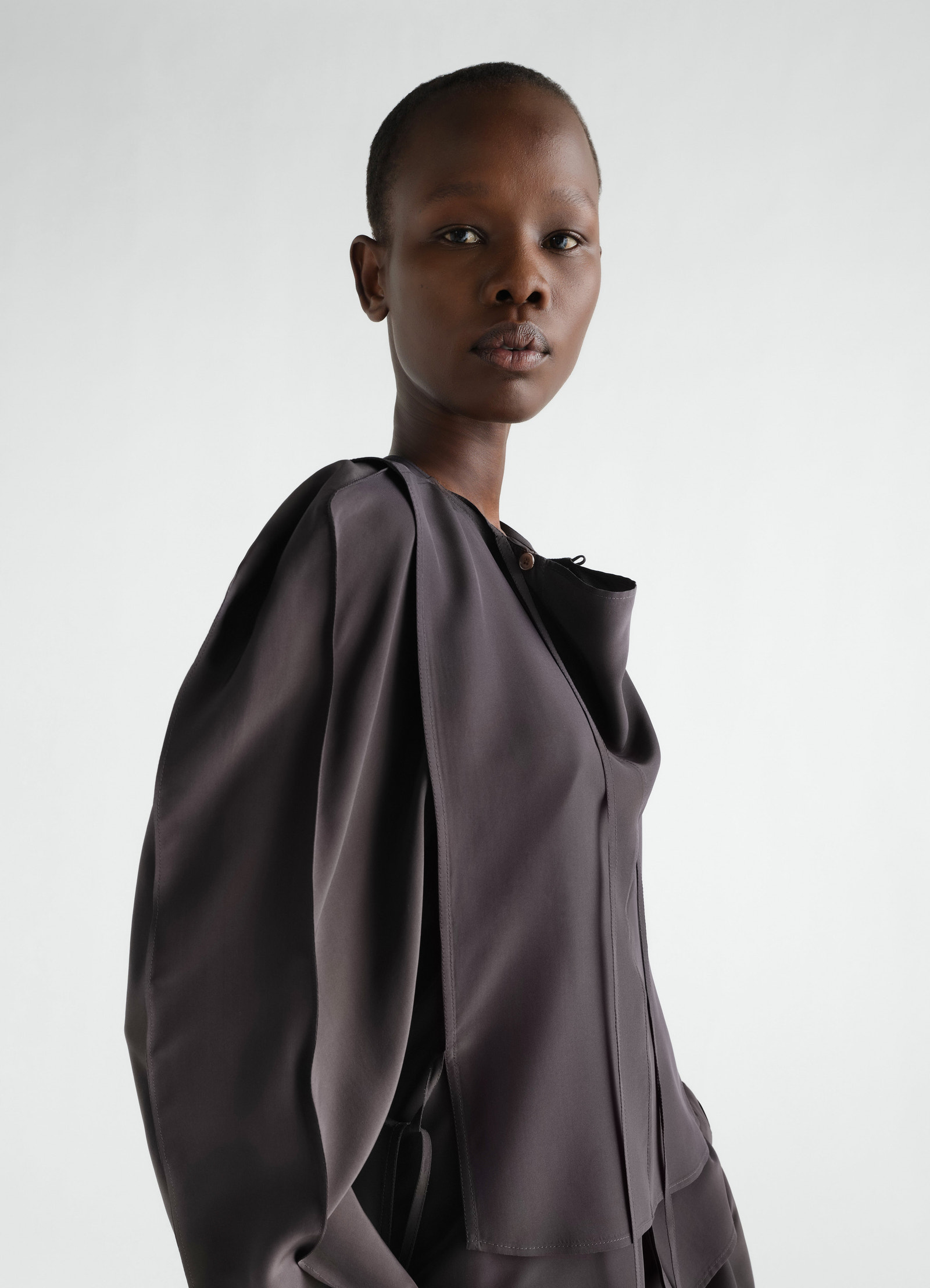 Layered dark grey silk and viscose blouse worn by model front side view lemaire