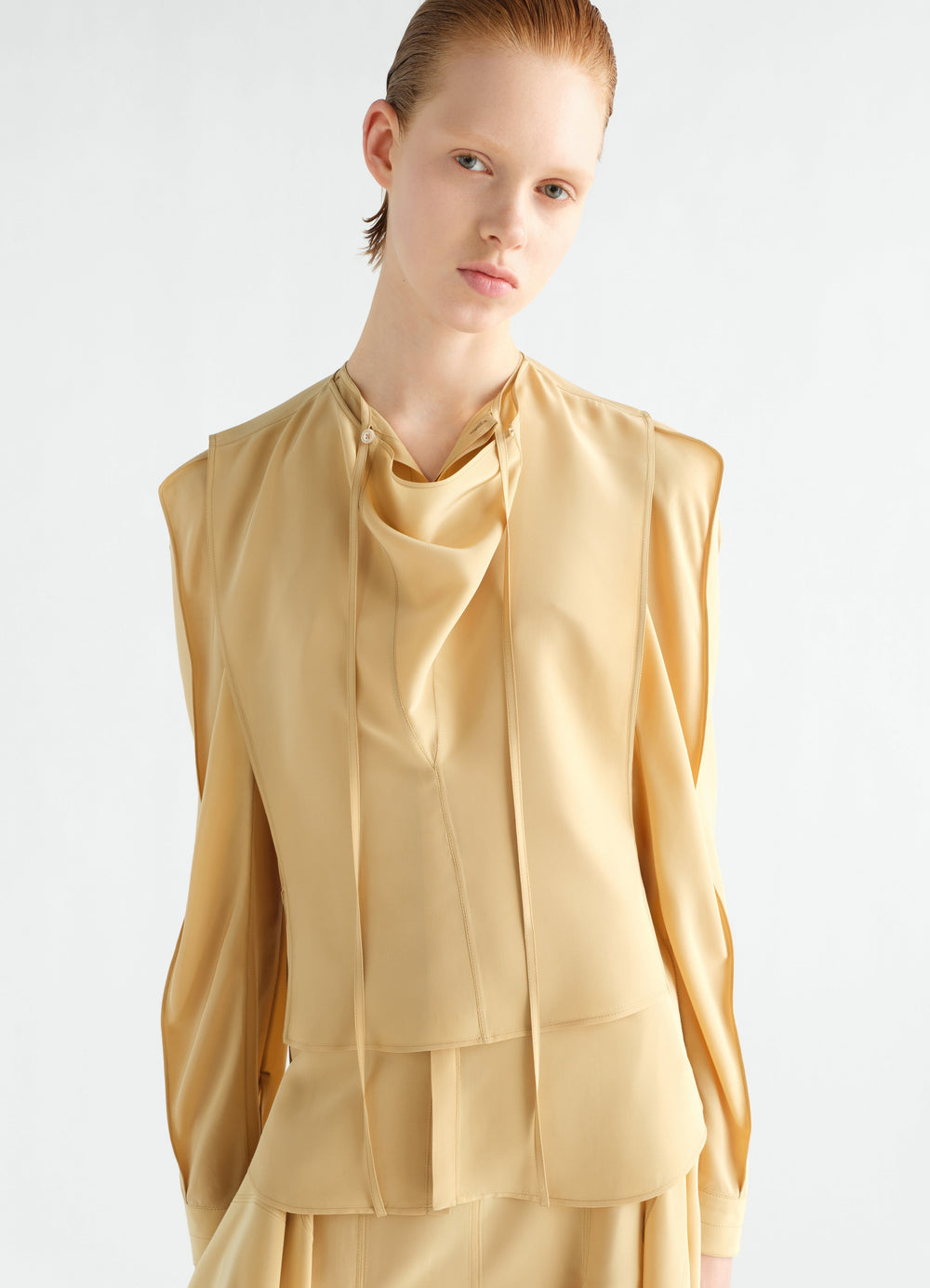 Layered beige silk and viscose blouse with draped neck worn by model LEMAIRE front view