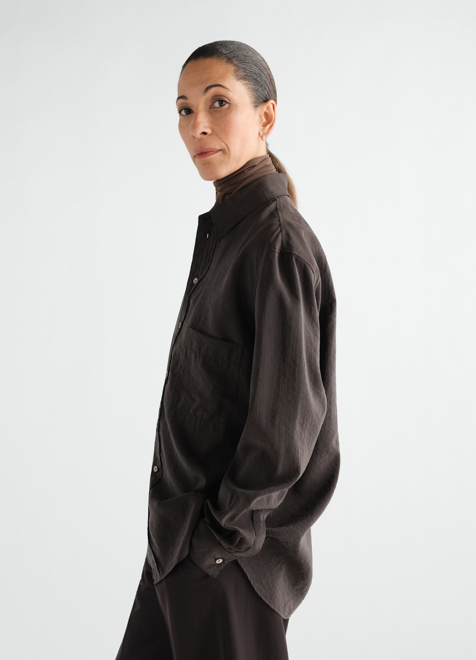 Straight shirt in brown dry silk worn by a model side view lemaire