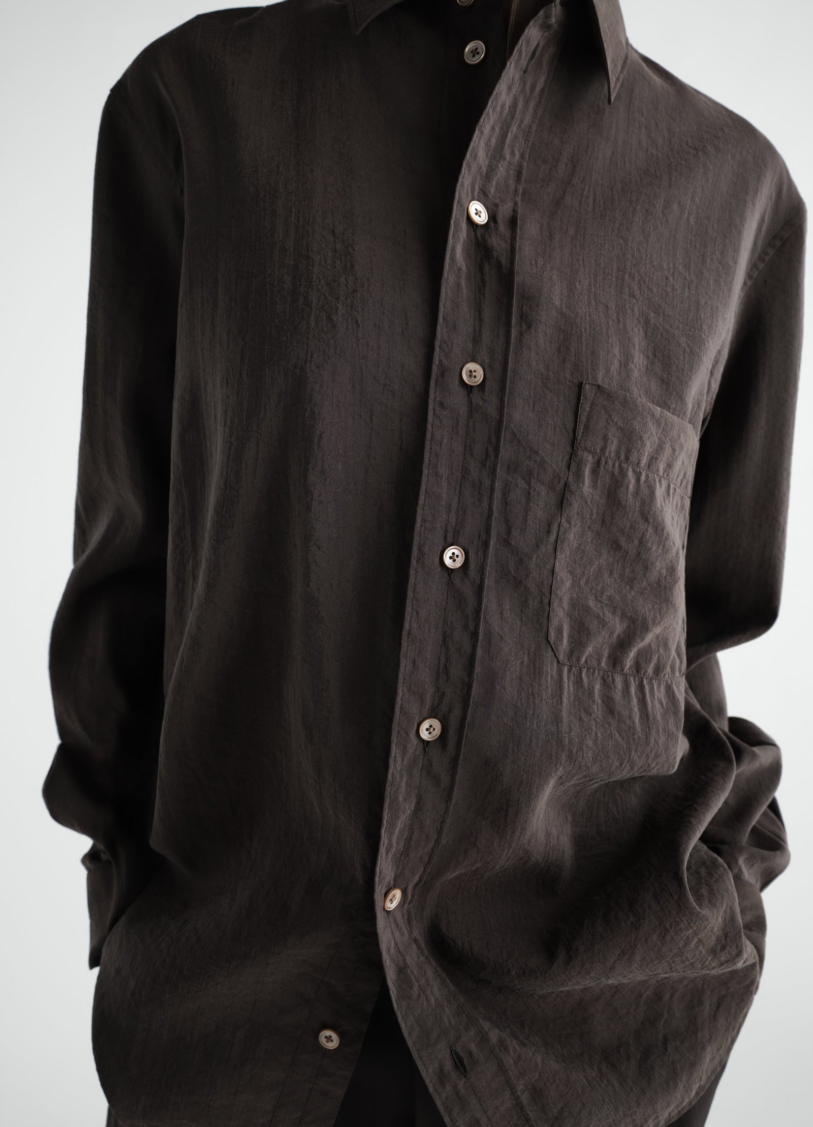 Straight brown dry silk shirt with pocket and buttons worn by model lemaire close-up front view