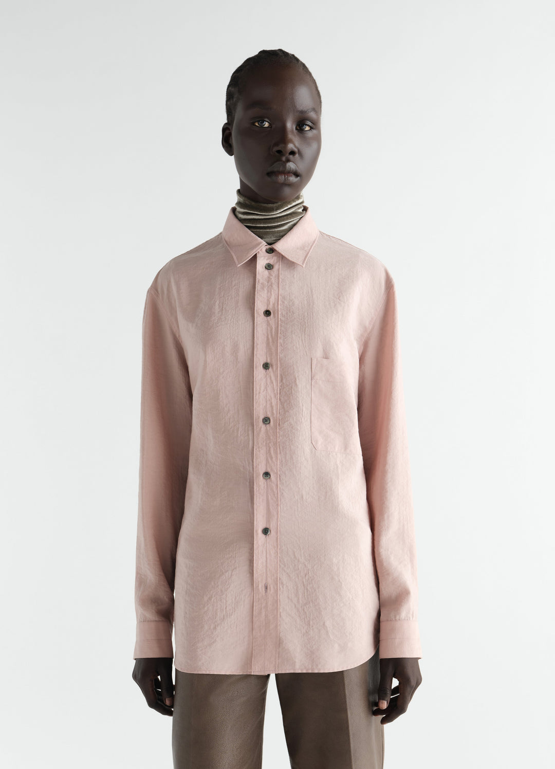 Straight pink dry silk shirt by LEMAIRE worn by model front view with button detail and collar