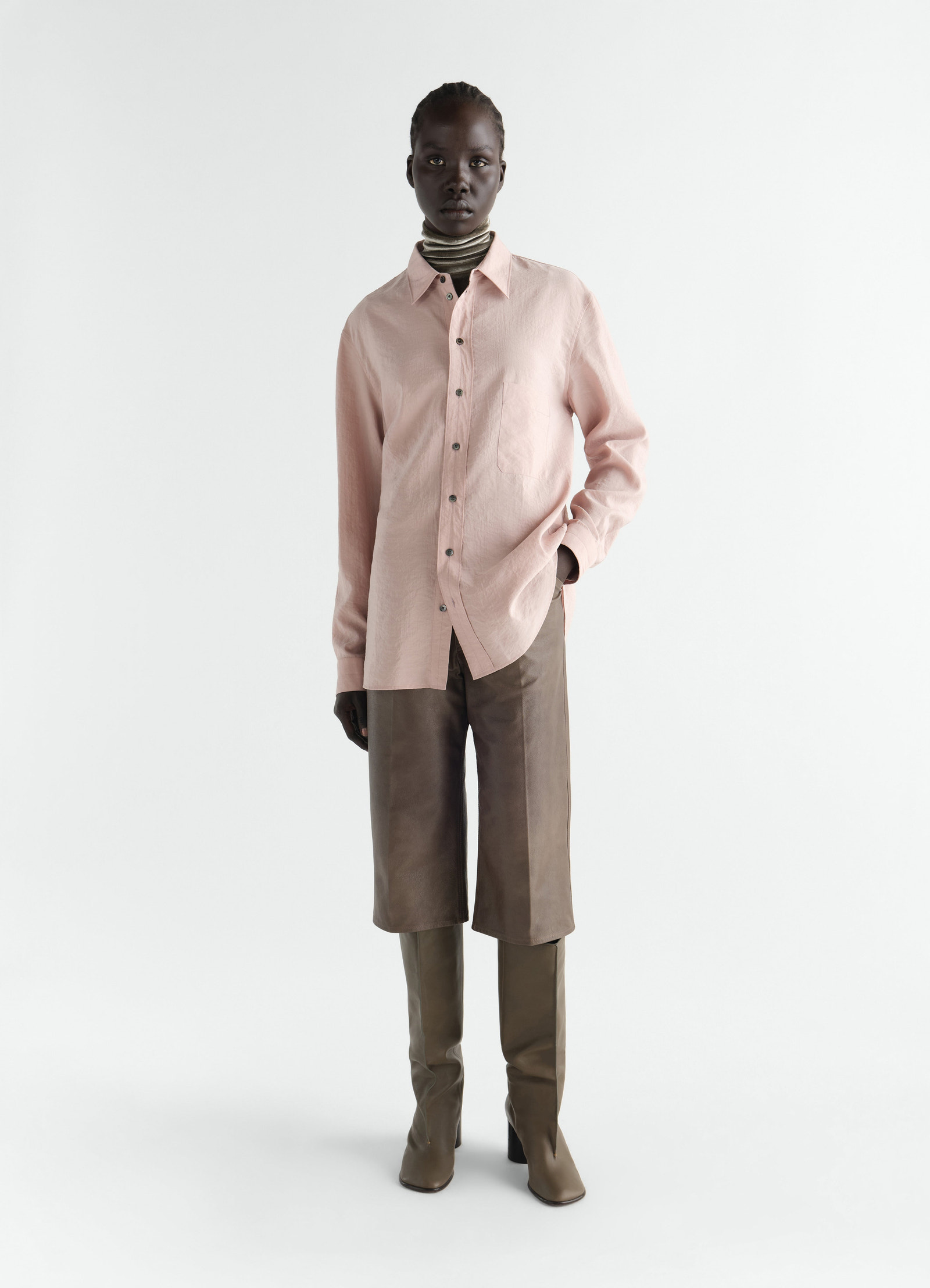 Straight dry silk pink shirt worn by a model with brown leather shorts and boots lemaire front view