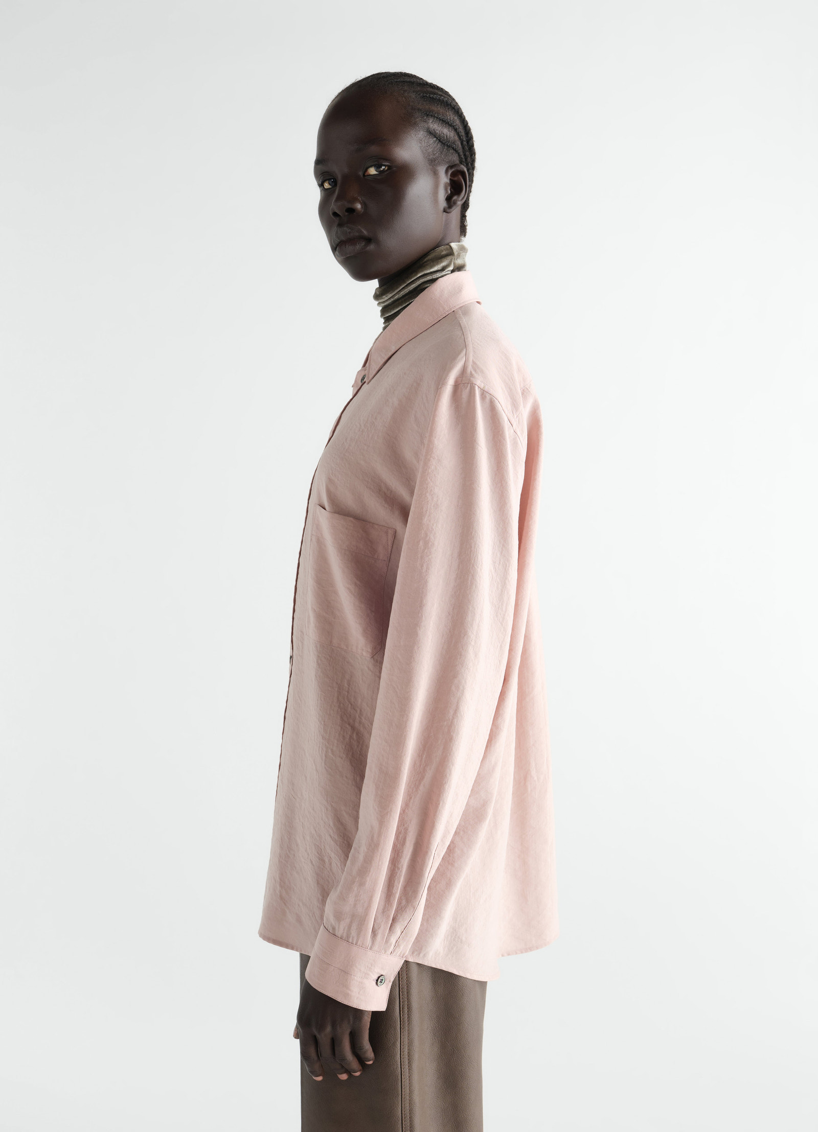 Straight dry silk pink shirt by lemaire worn by model side view with long sleeves and pocket detail