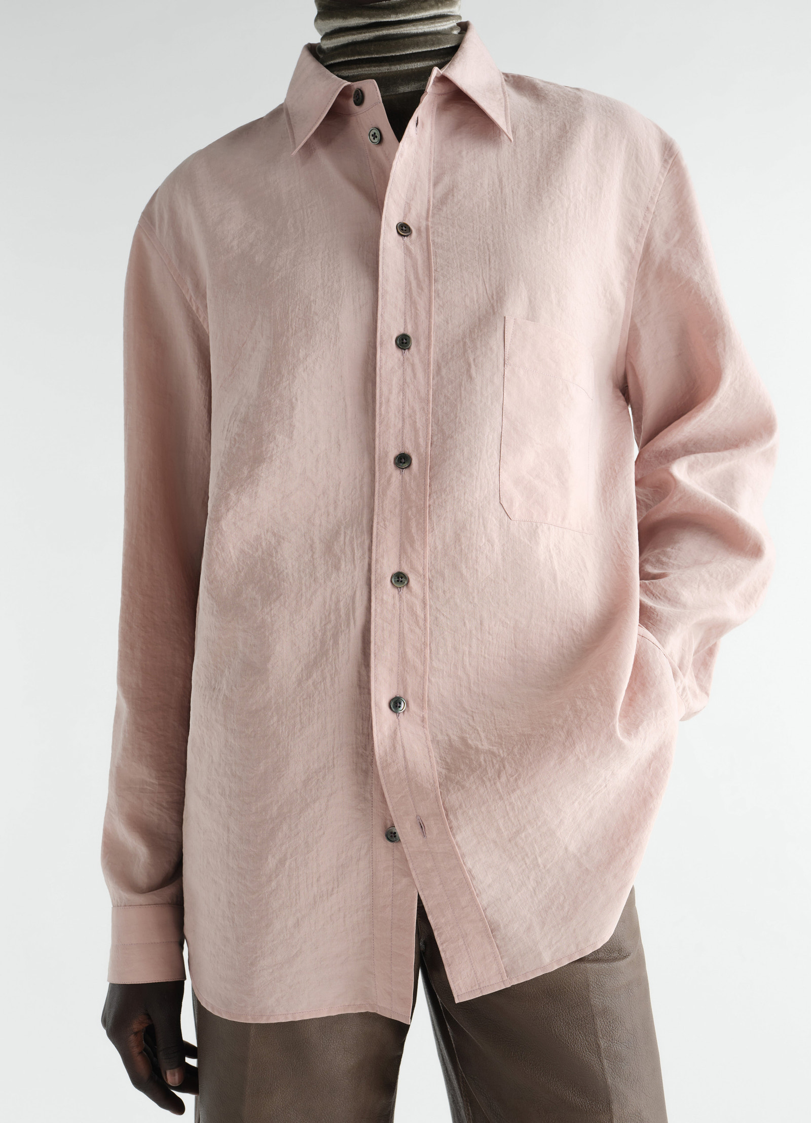 Straight pink dry silk shirt lemaire front view worn by model with turtleneck and leather pants