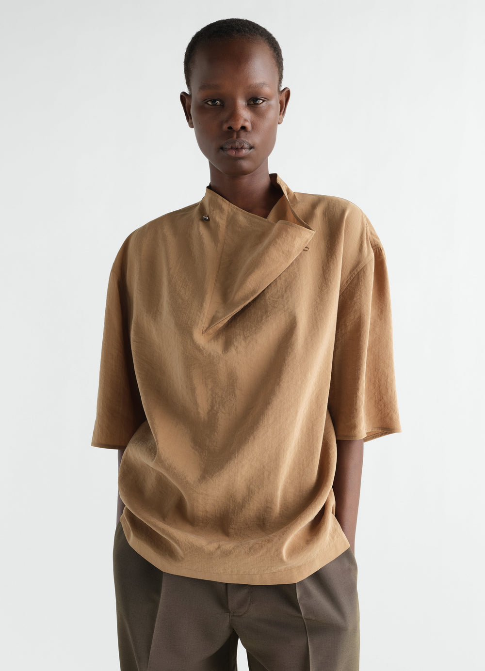 Soft collar top in camel dry silk worn by model front shot LEMAIRE