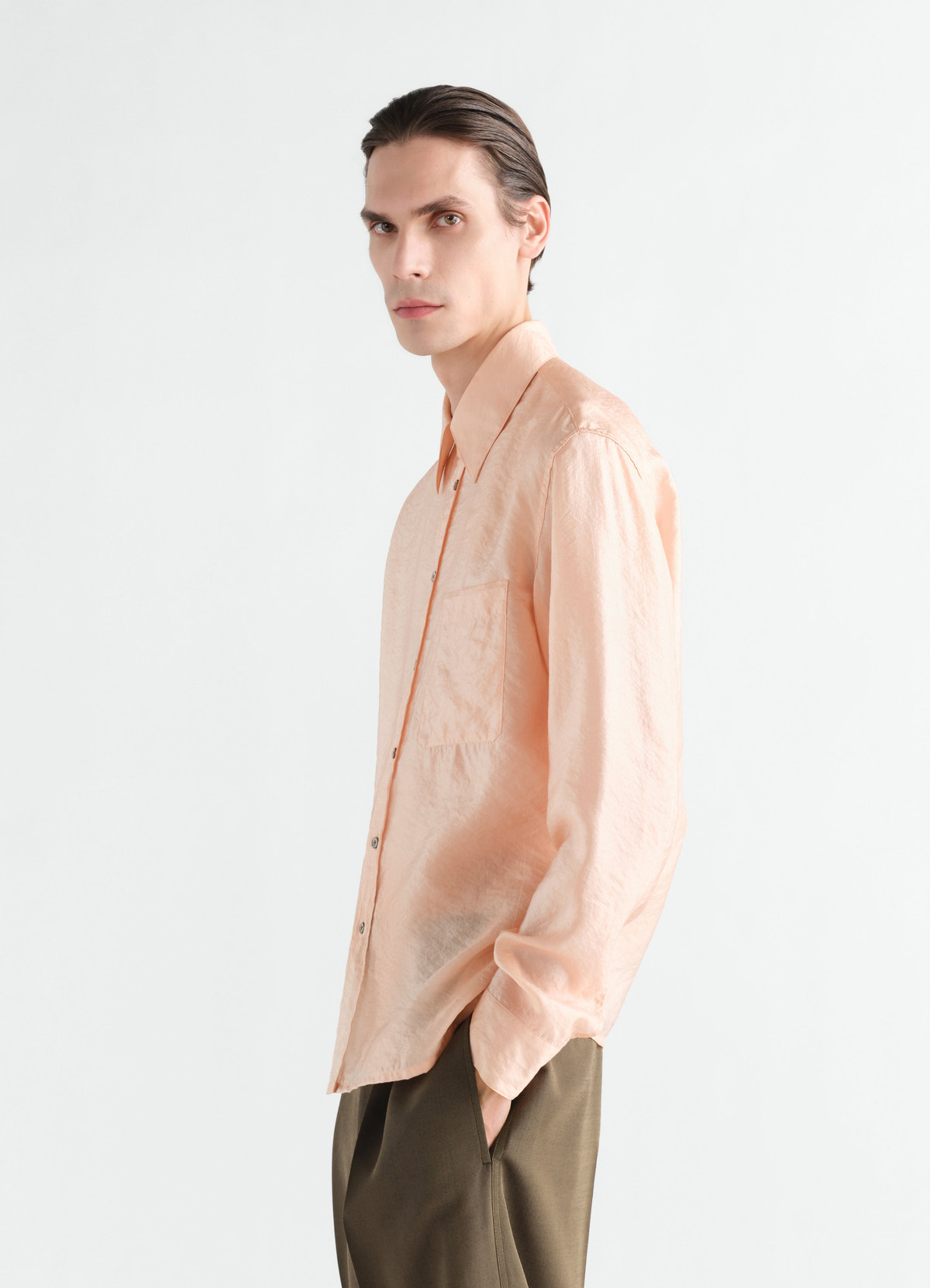 Fitted peach shiny cupro shirt with front pocket worn by model side view lemaire