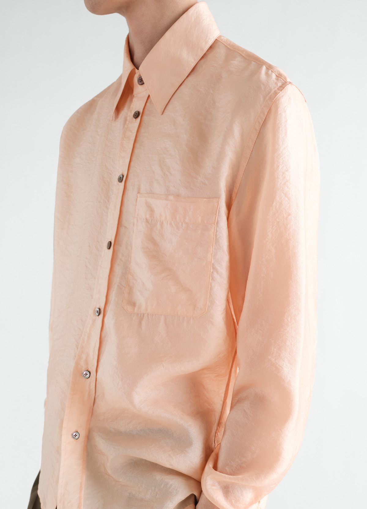 Fitted shiny peach cupro shirt with chest pocket by lemaire worn by model front side view