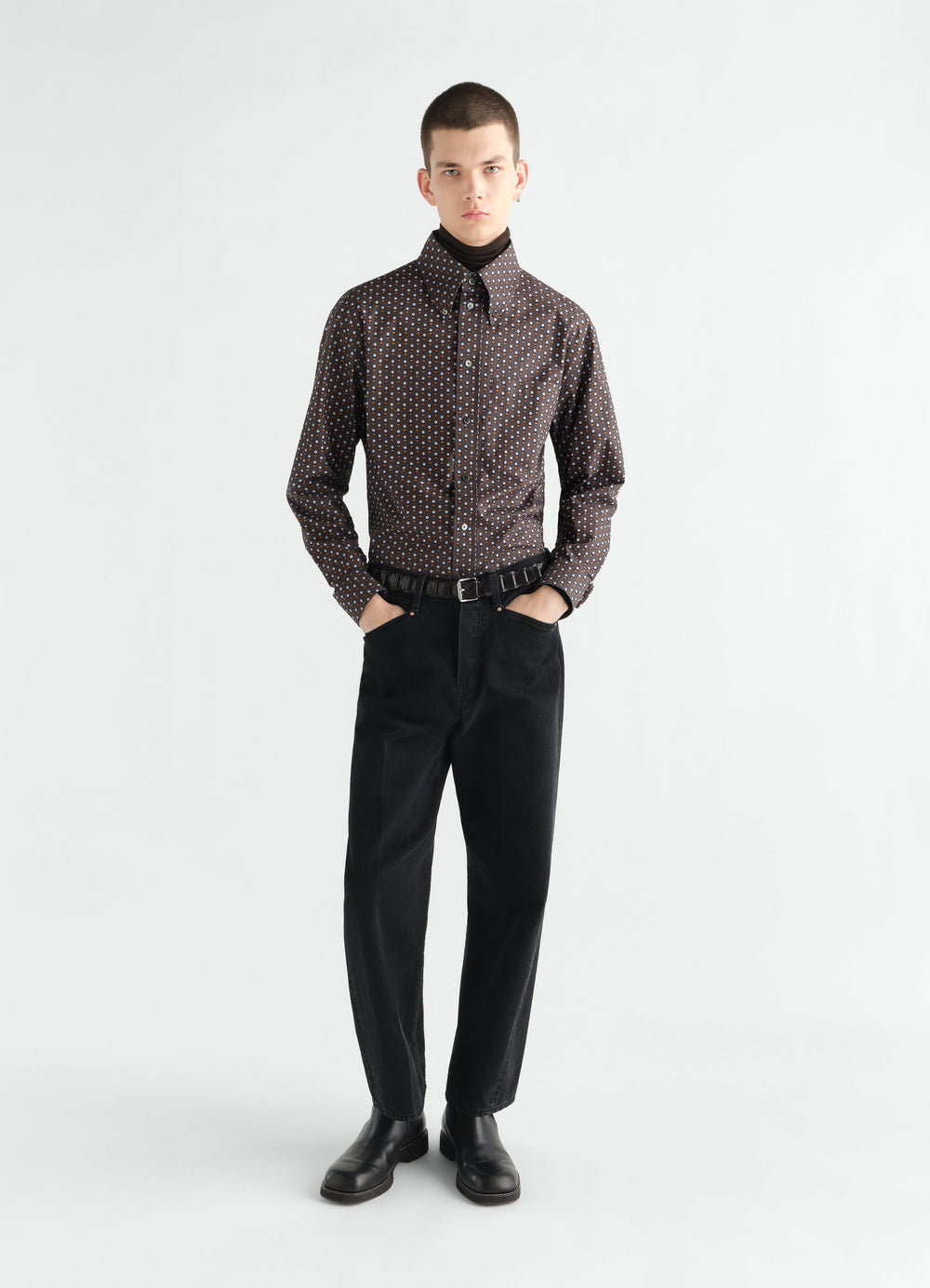 Button-down shirt in brown circle printed cotton worn by model with black pants and boots LEMAIRE front view
