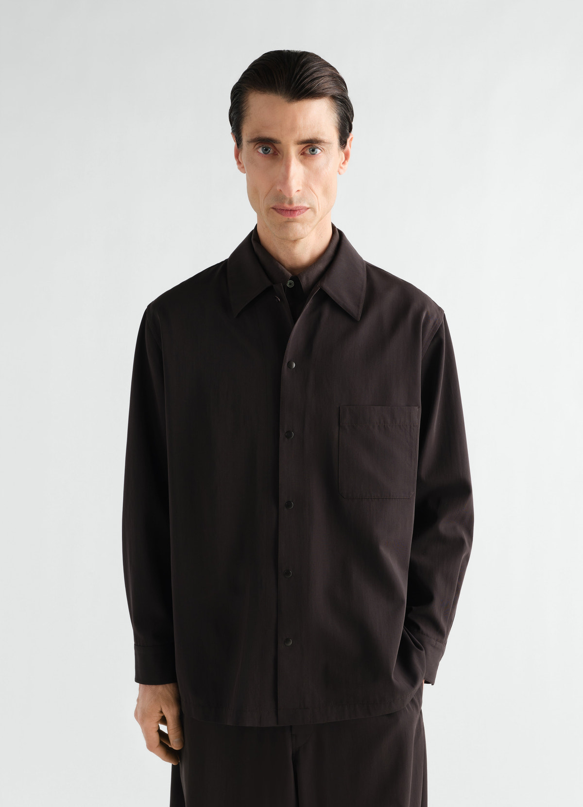 Light black wool gabardine overshirt with front pockets worn by model lemaire front view