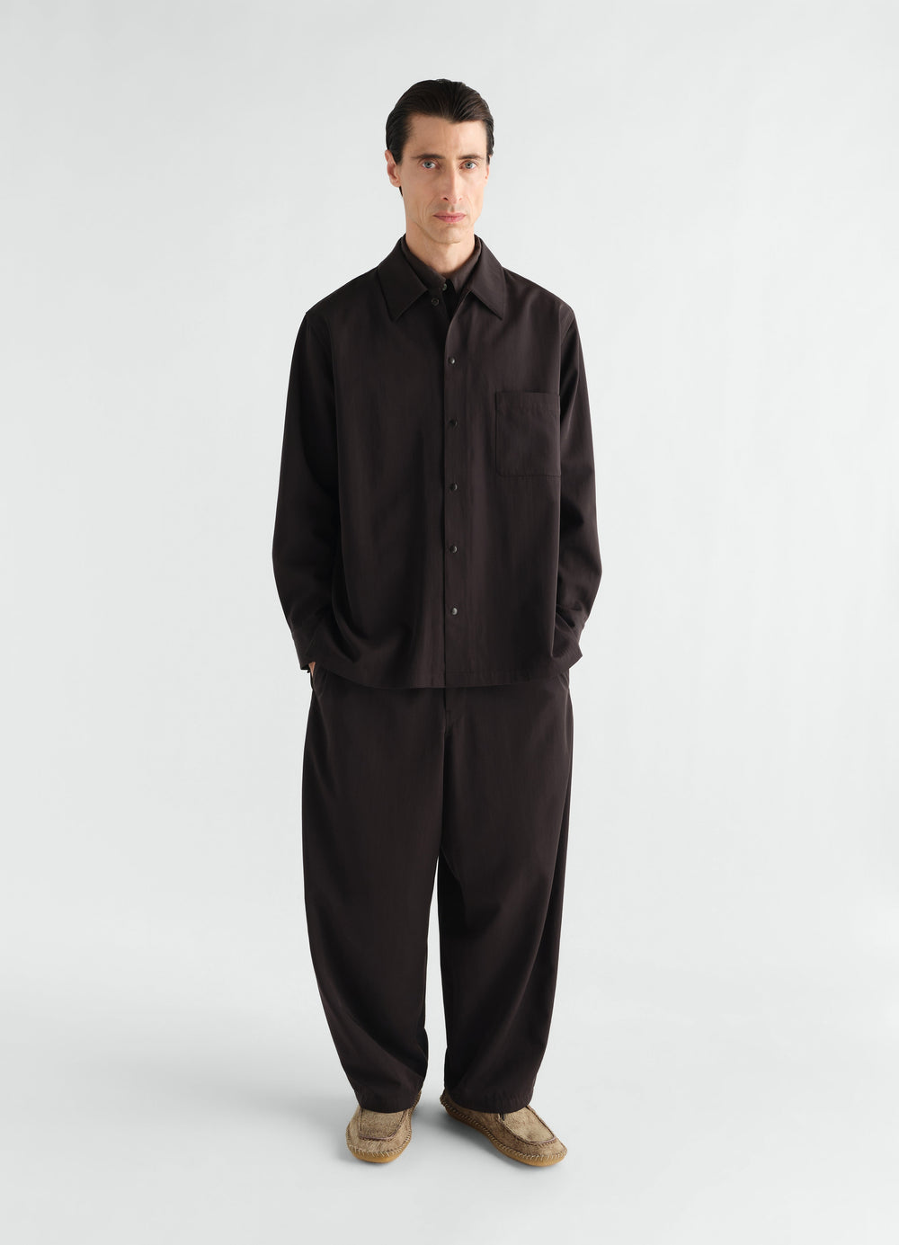 Light black wool gabardine overshirt with chest pocket worn by model front view LEMAIRE