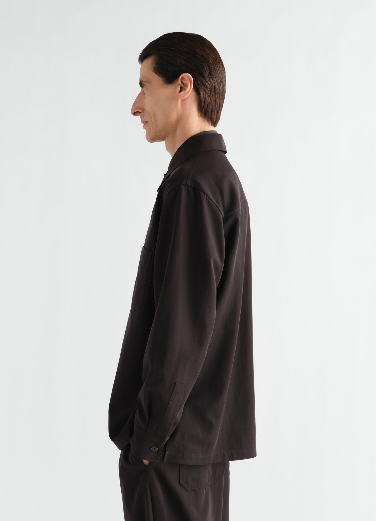 Light black wool gabardine overshirt by lemaire worn by model side view with pocket detail