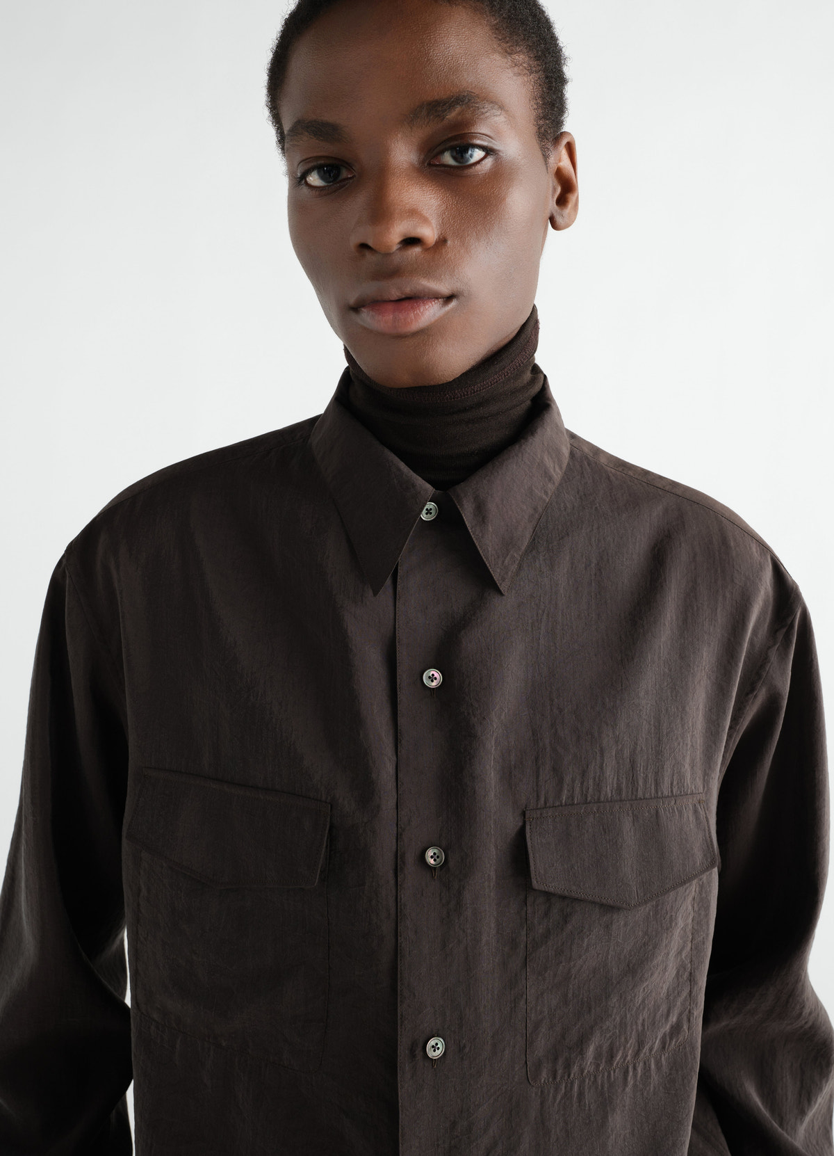 Convertible collar dry silk shirt in dark brown by lemaire worn by model front close-up