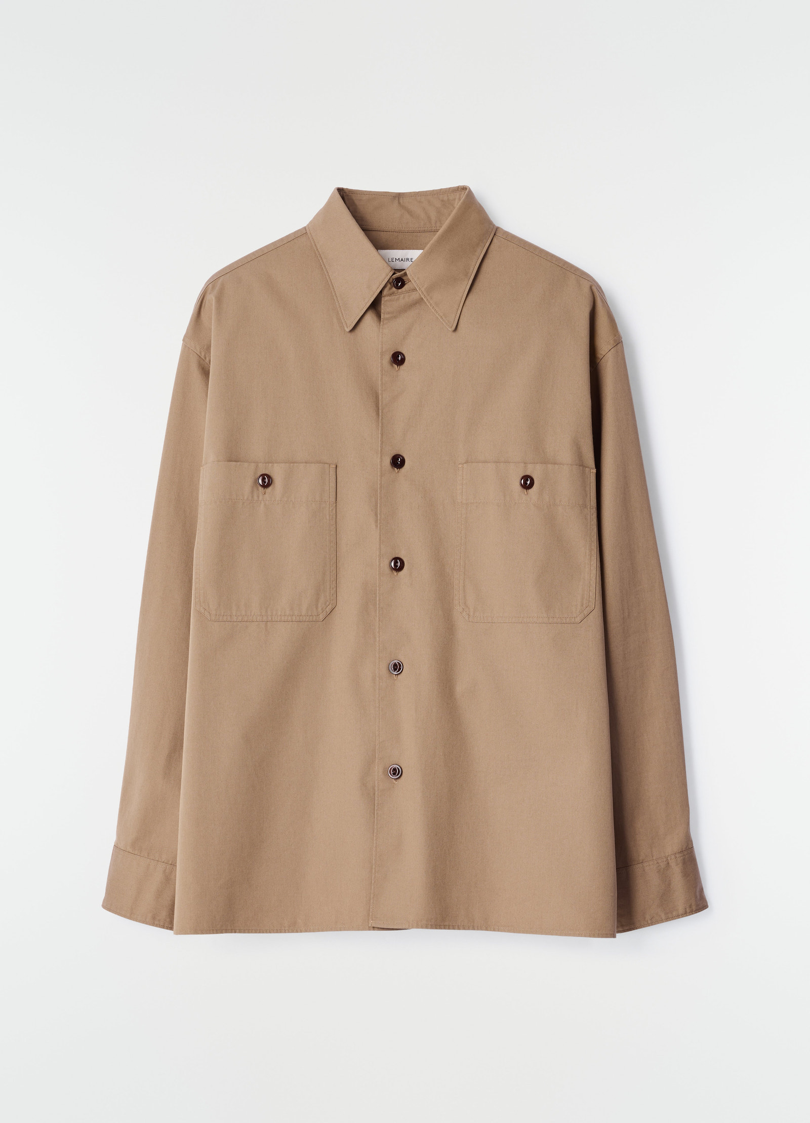 Two-pocket cotton twill shirt in light brown by lemaire flat lay on white background with button details