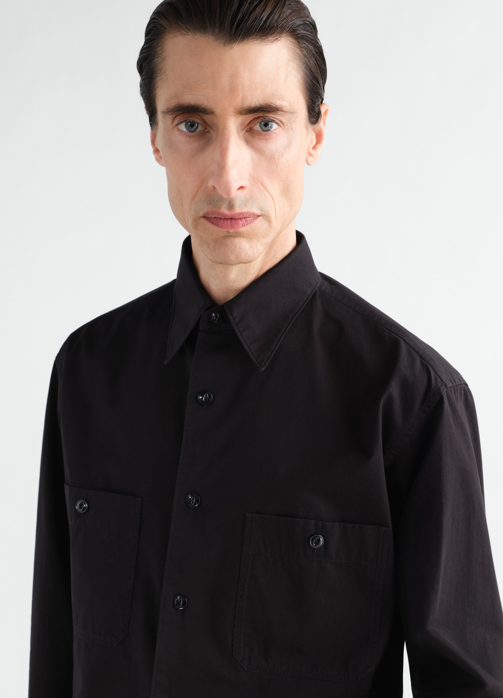 Two-pocket black light cotton twill shirt by lemaire worn by model front view close-up