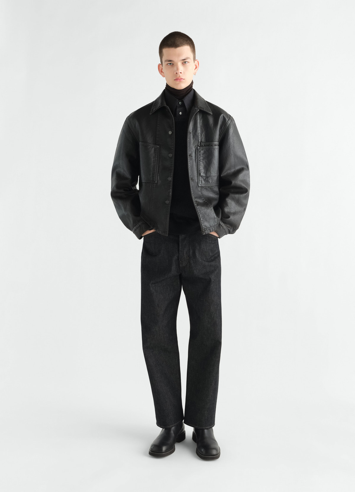 Workwear overshirt in black coated denim worn by model front view lemaire