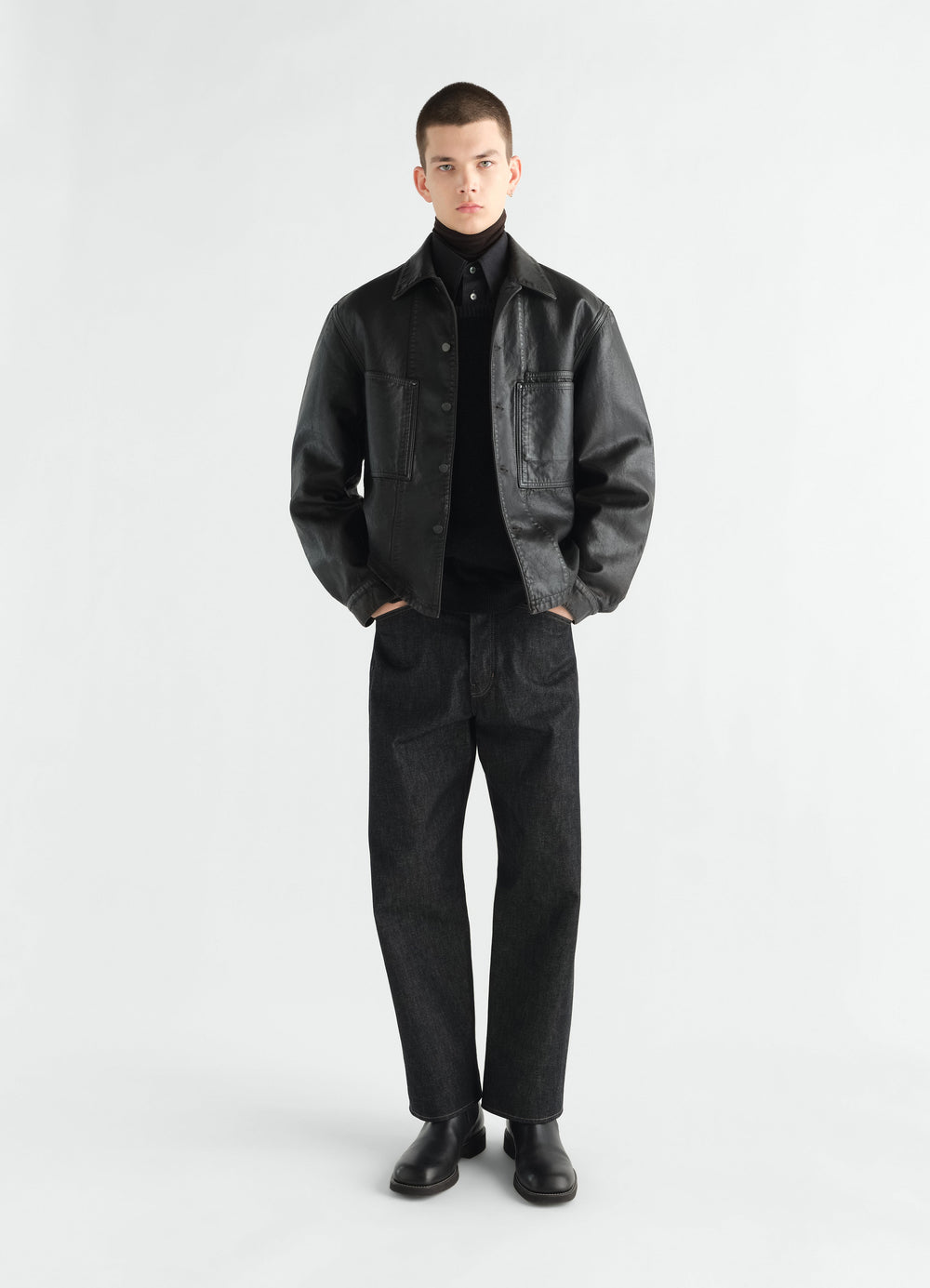Workwear overshirt in black coated denim worn by model front view LEMAIRE